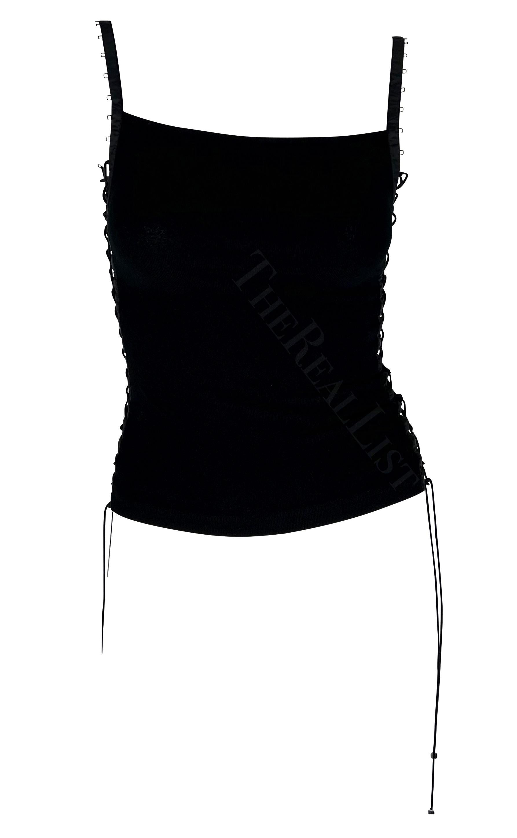 TheRealList presents: a black lace-up Dolce and Gabbana tank top. From the Spring/Summer 2003 collection, this ultra-sexy tank top features a square neckline and is elevated with a lace-up adjustable corsetry accent on either side. Simple and chic,