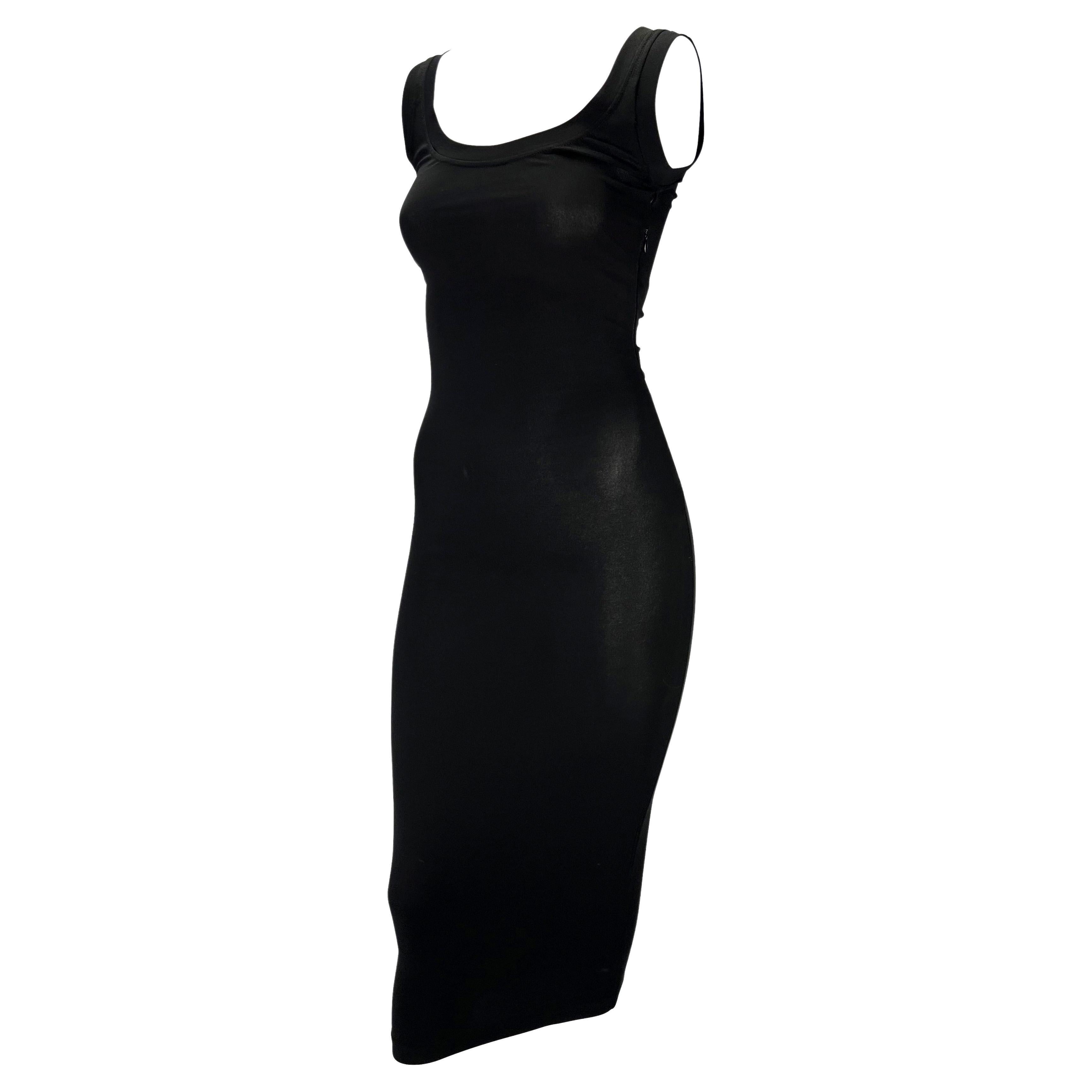 Presenting a beautiful black bodycon Dolce and Gabbana dress. From the Spring/Summer 2003 'Sex & Love' collection, this stunning form-fitting dress is the perfect versatile little black dress. The dress features a scoop neckline and back and is made