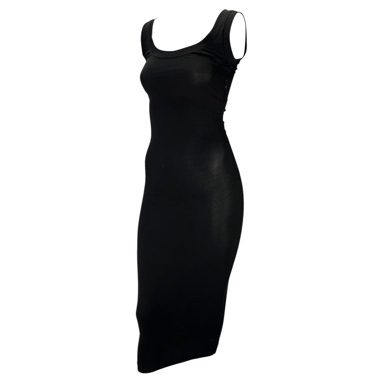 TheRealList presents: a beautiful black bodycon Dolce and Gabbana dress. From the Spring/Summer 2003 'Sex & Love' collection, this stunning form-fitting dress is the perfect versatile little black dress. The dress features a scoop neckline and back