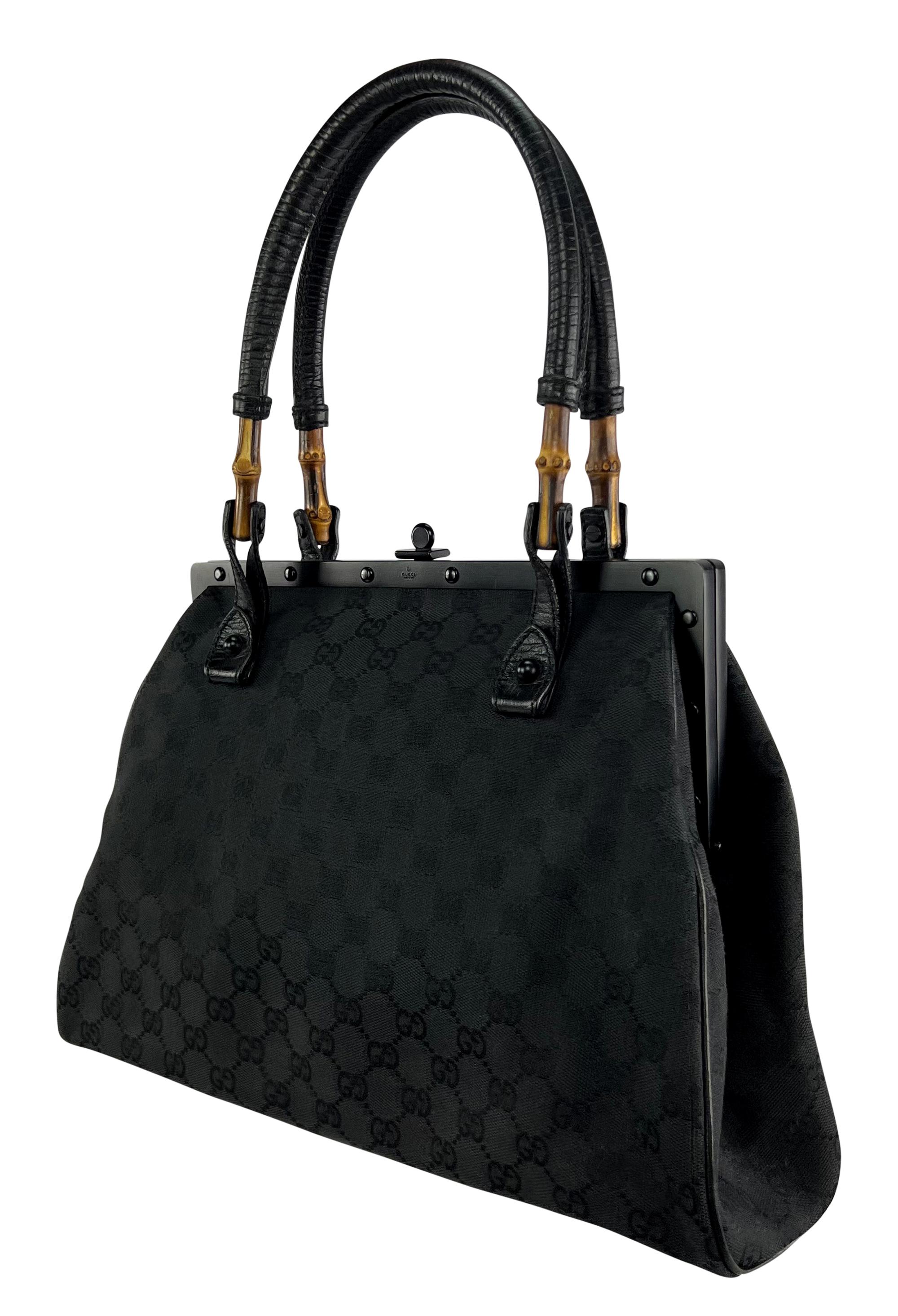 From the Spring/Summer 2003 collection, this Gucci by Tom Ford black canvas bag is covered in the brand's famous 'GG' pattern. This sleek shoulder tote features a black metal clamshell closure and is complete with bamboo accents at the leather