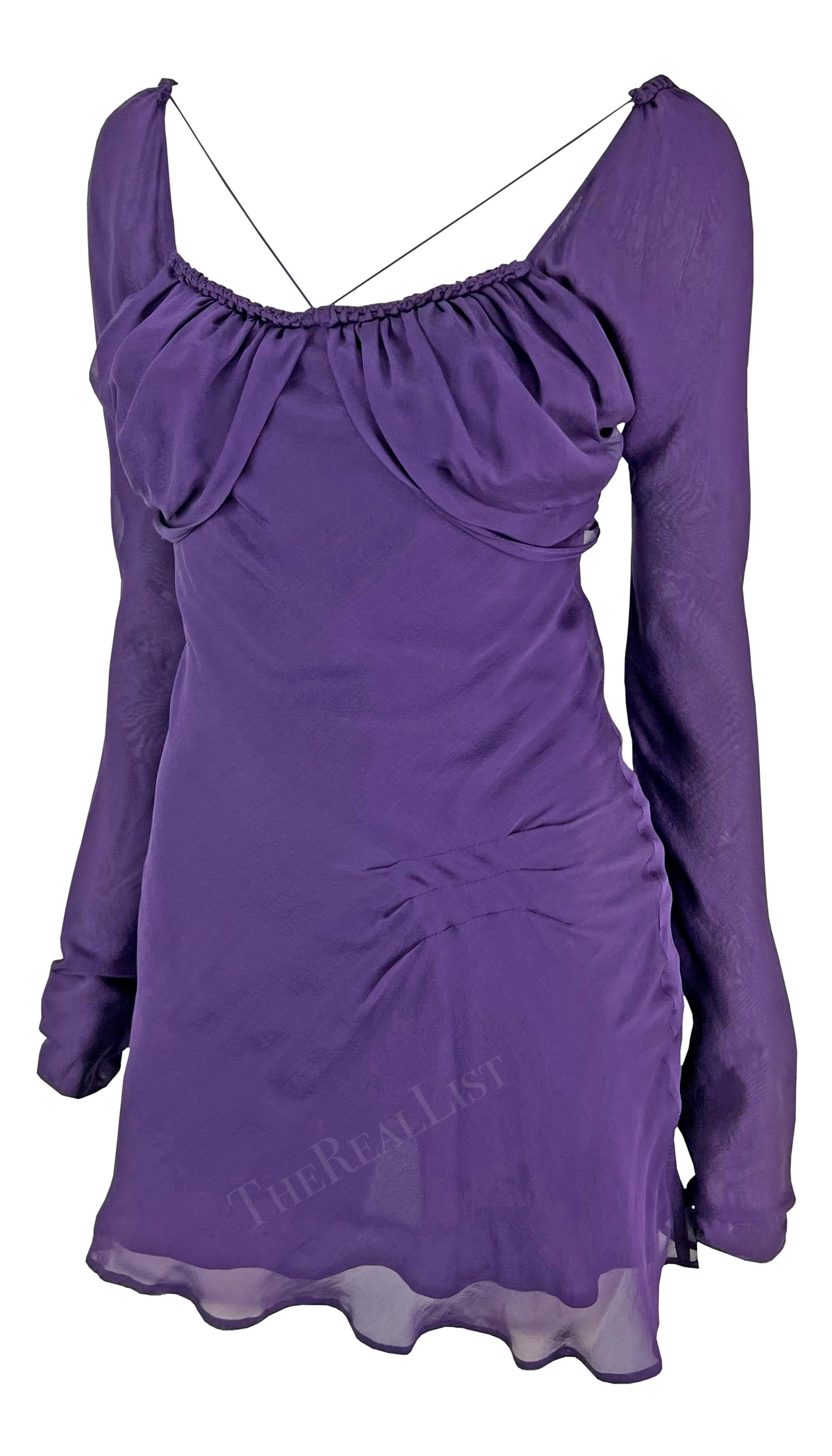 Presenting a chic deep purple Gucci mini dress, designed by Tom Ford. From the Spring/Summer 2003 collection, this silk mini dress features ruching at the bust, a gathered accent at the front, a flared skirt, and long sleeves. This fabulous dress is