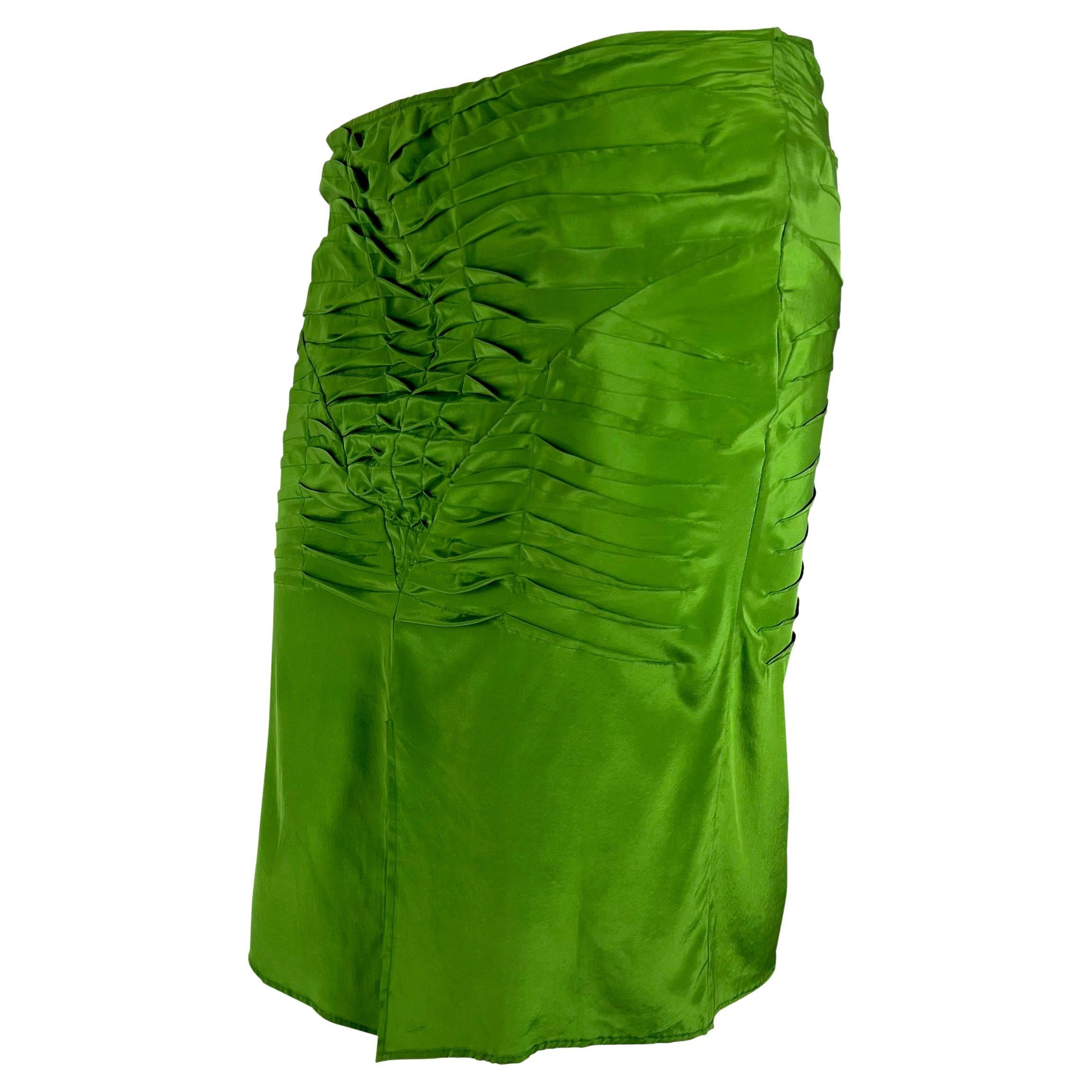 Presenting a vibrant green Gucci skirt, designed by Tom Ford. From the Spring/Summer 2003 collection, this silk skirt features pleated ruches around the hips and a slit at the front. The intentional pleats beautifully outline the body, enhancing its