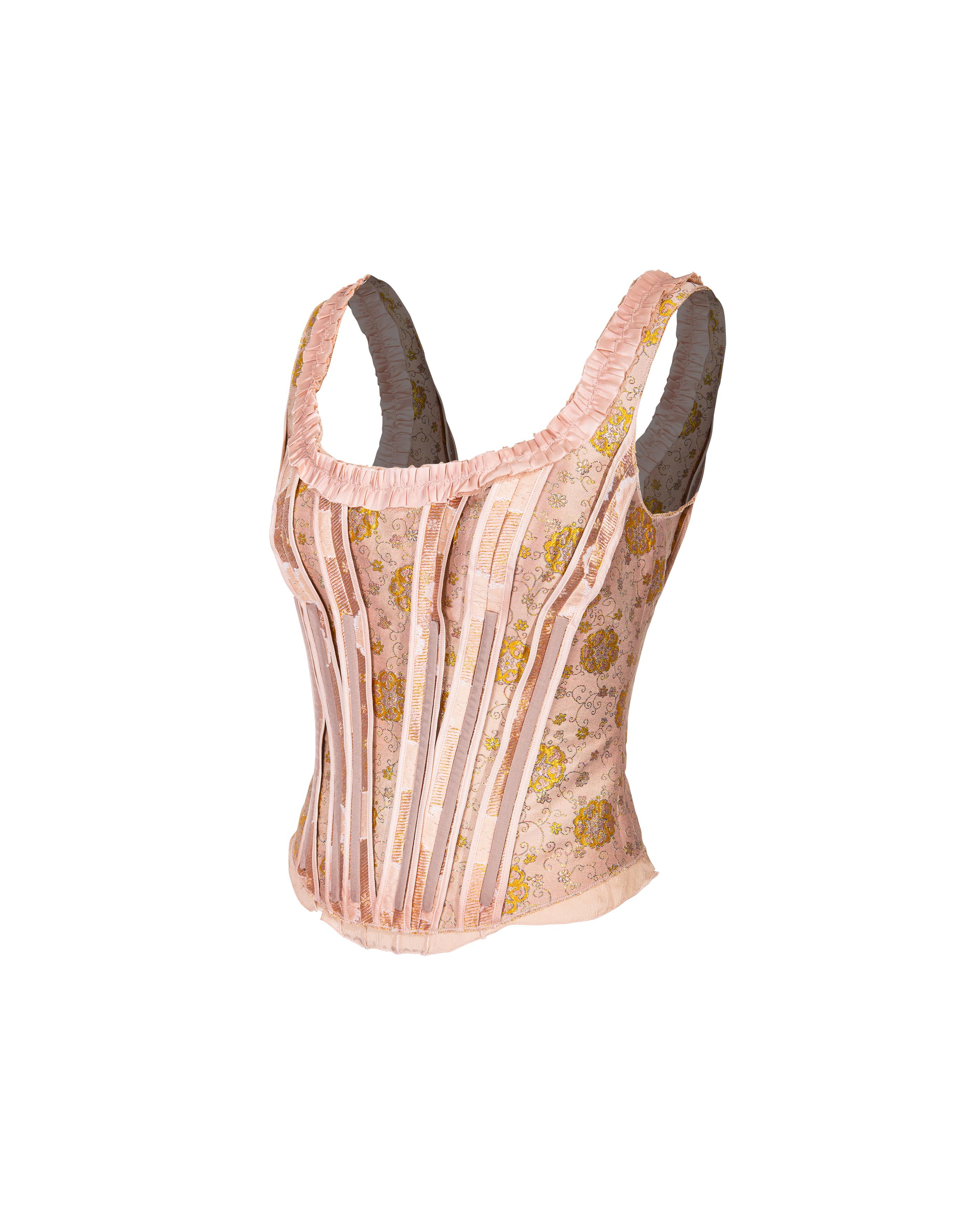 S/S 2003 Prada by Miuccia Prada blush pink floral brocade corset top with exterior gray boning. Pink silk corset with silk chiffon hemline and metallic gold floral detailing. Pink ruffle neckline and back ribbon tie. Back zip closure. An intricate