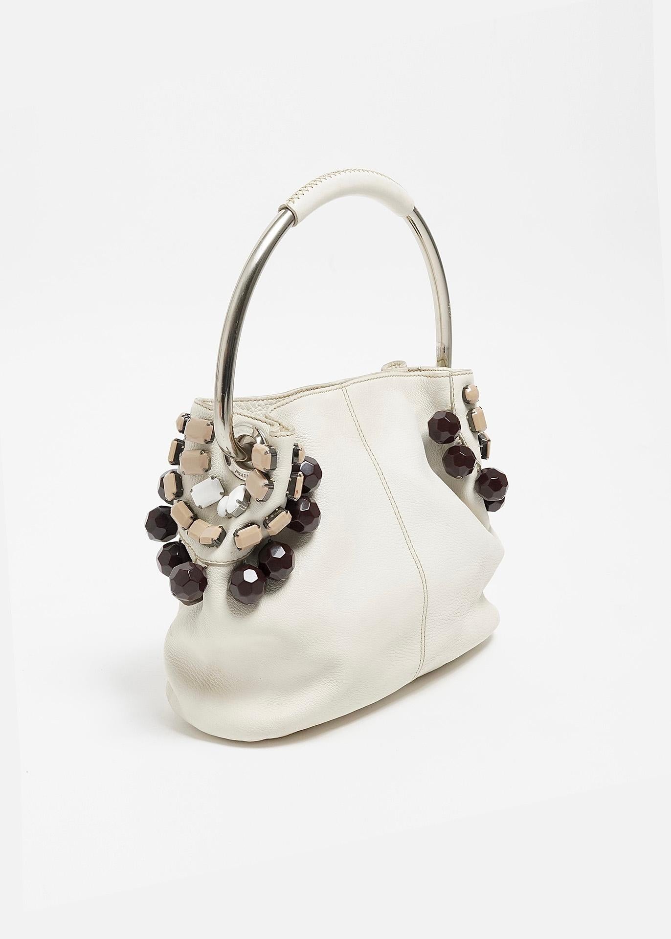 Miuccia Prada introduced the much sought after metal hoop handbag as part of the Prada Spring/Summer 2003 collection. A collection widely celebrated for its effortless merging of luxury, sport, color as well as '60s elements. The bag on offer here