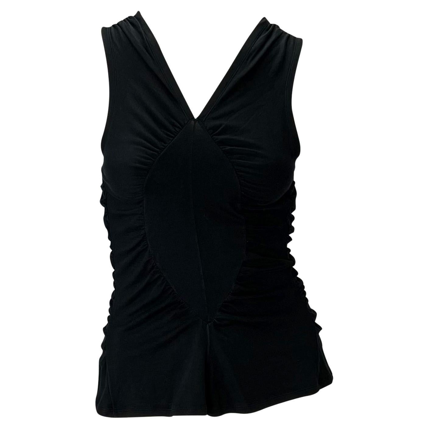 Presenting a black ruched tank top designed by Tom Ford for Yves Saint Laurent Rive Gauche's Spring/Summer 2003 collection. Not your average tank, this piece is all about the power of ruching. Ford used this sewing technique to create identical