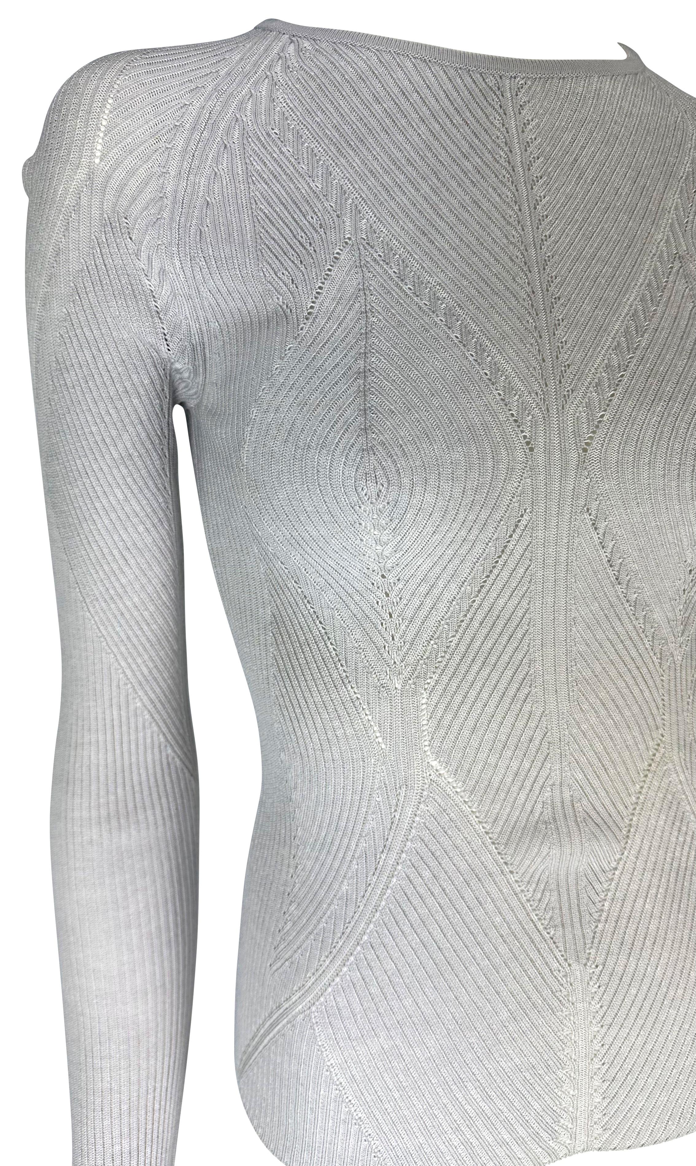 TheRealList presents: a beautiful lavendar knit Yves Saint Laurent sweater, designed by Tom Ford. From the Spring/Summer 2003 collection, this ribbed sweater features a diamond pattern that tactfully covers the breasts and provides a nude illusion.