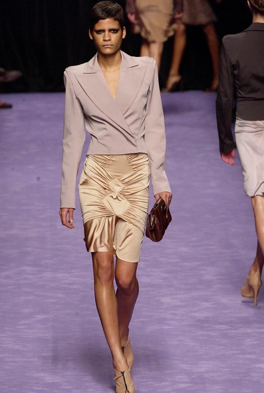 Presenting a black stretch viscose blend skirt designed by Tom Ford for Yves Saint Laurent Rive Gauche's Spring/Summer 2003 collection. The beige/taupe version of this skirt debuted on the season's runway as part of look 3 on Omahyra Mota and in a