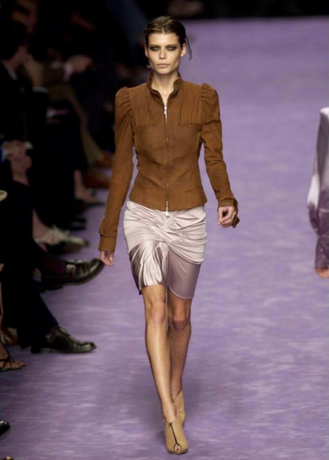 Presenting a brown stretch viscose blend skirt designed by Tom Ford for Yves Saint Laurent Rive Gauche's Spring/Summer 2003 collection. This skirt's beige/taupe version debuted on the season's runway as part of Look 3 on Omahyra Mota and in a