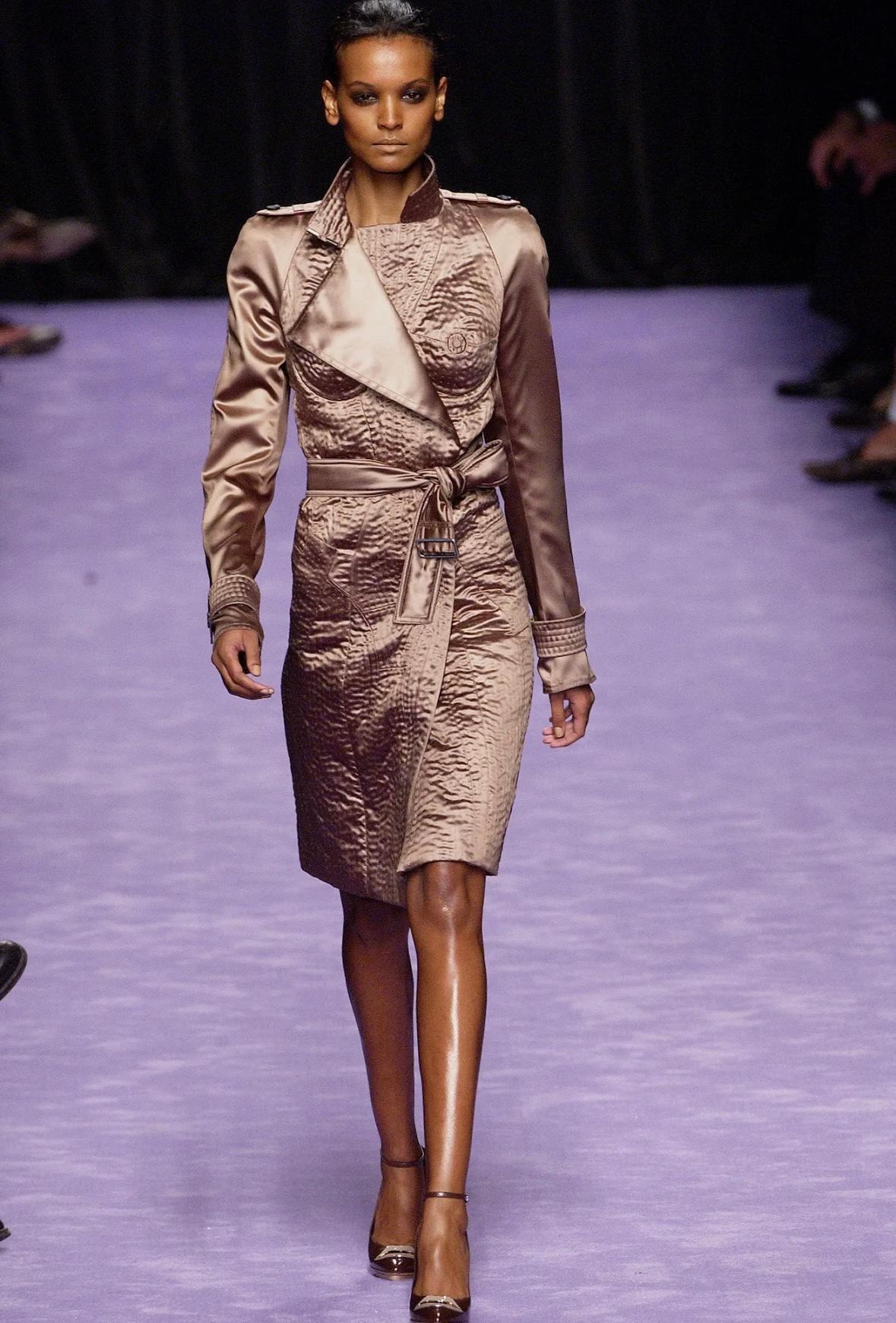 This surrealist nude detail trench coat was designed by Tom Ford for Yves Saint Laurent Rive Gauche. This coat is a rare prototype of look four on the Spring/Summer 2003 runway, worn by Liya Kebede. Also captured by Guy Arch on Eva Riccobono for the