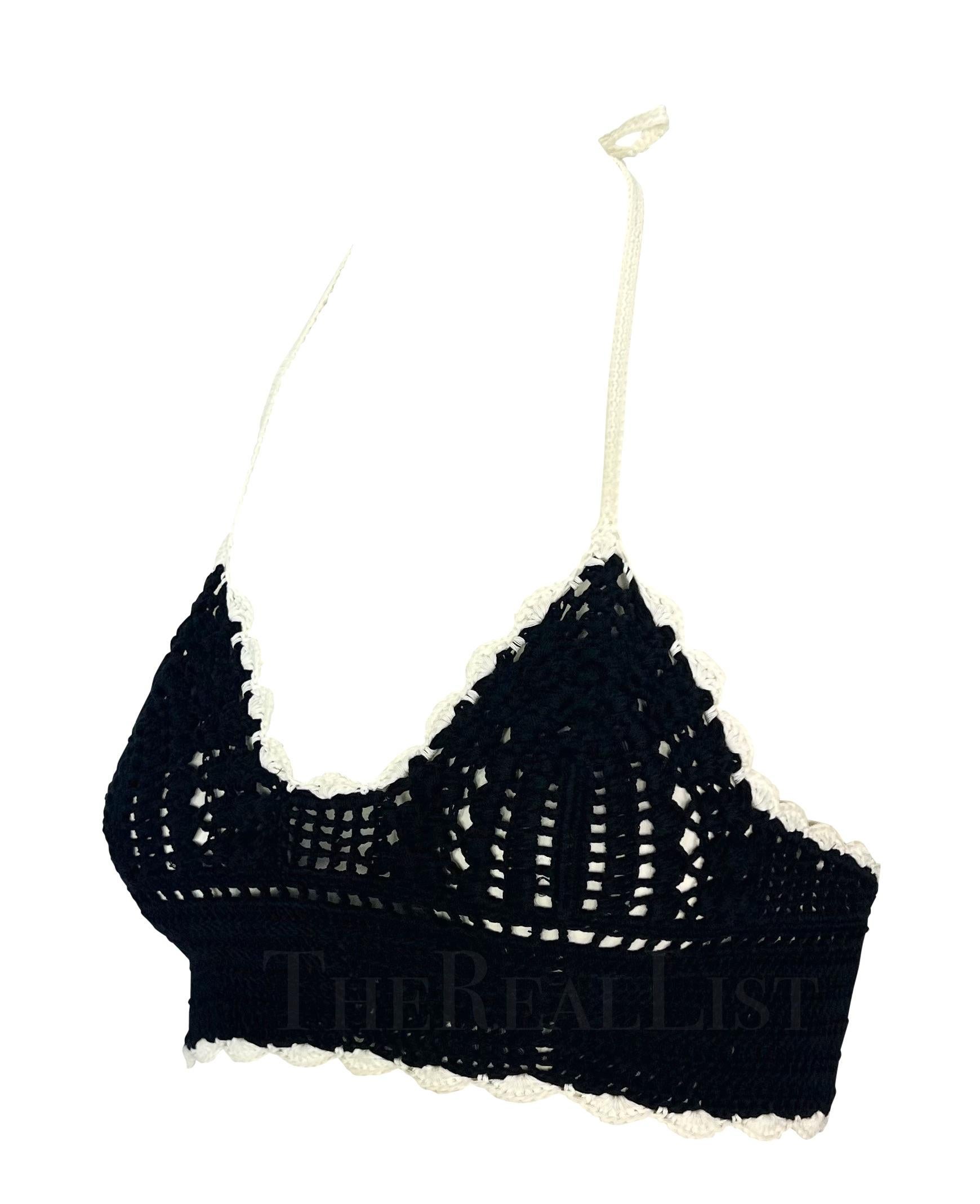 Presenting a fabulous black halterneck Chanel crochet crop top, designed by Karl Lagerfeld. From the Spring/Summer 2004 collection, the black crochet design is elevated with intricate white detailing at the hem. This chic top is the perfect elevated