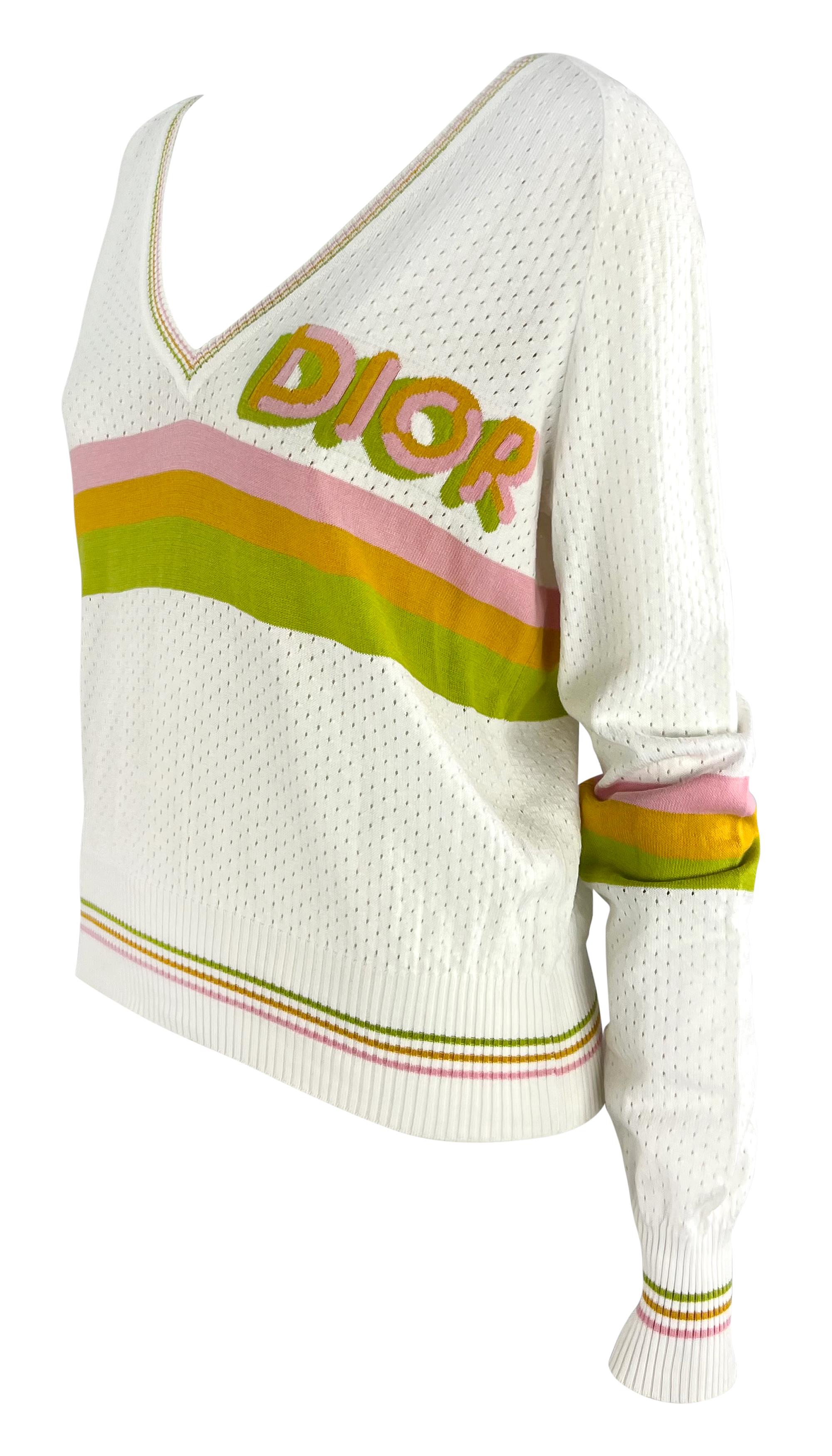 John Galliano designed this white Christian Dior sport jersey style sweater for his Spring/Summer 2004 ready to wear collection. This light weight top features perforations throughout, giving it an athletic jersey quality. The sweater features pink,