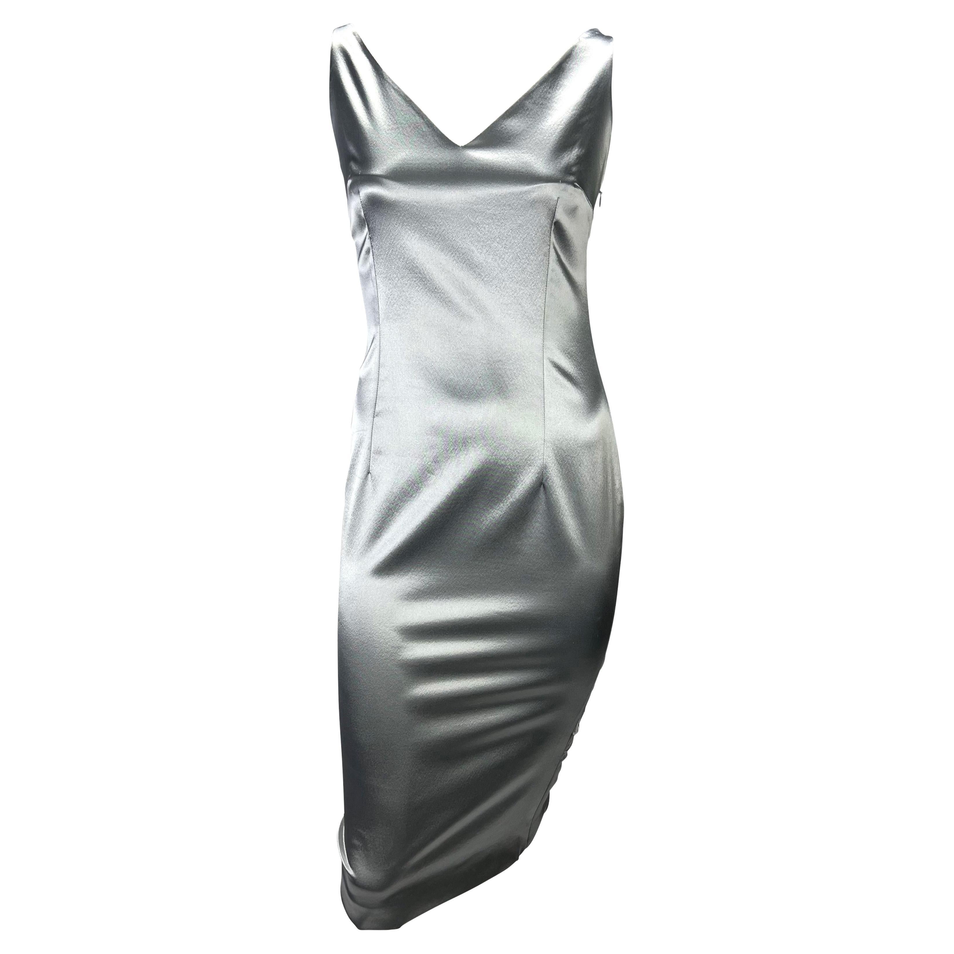 Presenting a beautiful silver satin Christian Dior Boutique dress, designed by John Galliano. From the Spring/Summer 2004 collection, this beautiful gunmetal-colored dress features a v-neckline, v-cutout at the back, and a gathered detail at the
