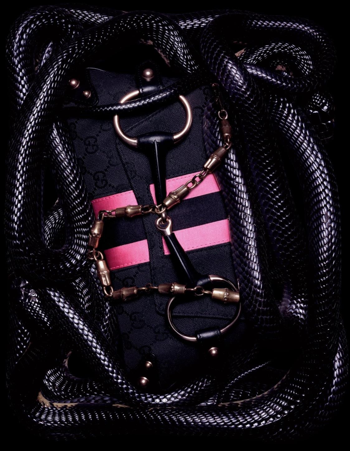 TheRealList presents: Designed by Tom Ford during his tenure at the house of Gucci, this bag represents Tom's interpretation of many of Gucci's classic elements ('GG' canvas, horse bits, etc.). Featured in the season's ad campaign, shot by Guido