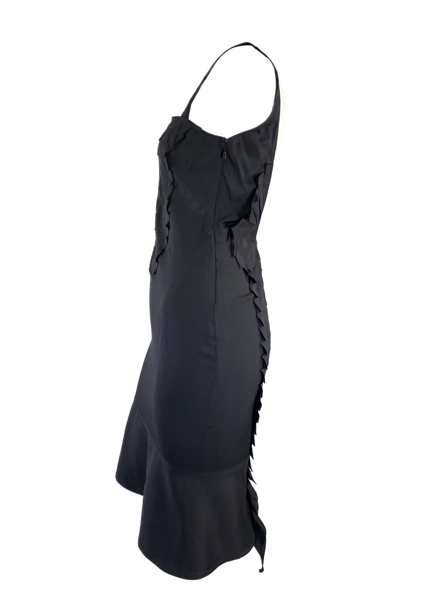 Presenting a black ribbon appliqué Gucci ribbon dress, designed by Tom Ford. From the Spring/Summer 2004 collection, this beautiful silk blend dress features a square neckline, flare skirt, and a plunging back. Like many pieces from this collection,