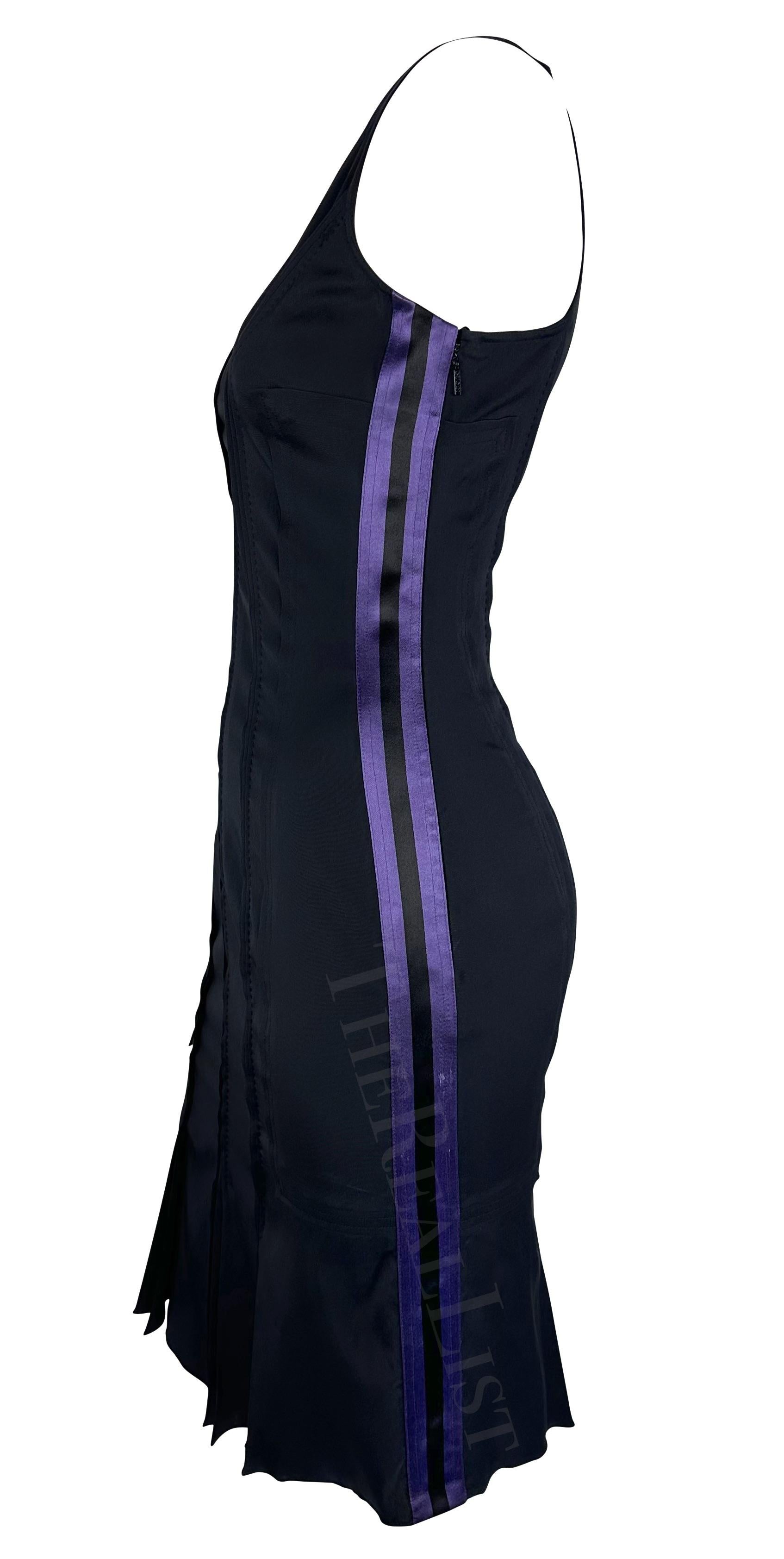TheRealList presents: an incredible black Gucci mini dress, designed by Tom Ford. From the Spring/Summer 2003 collection, pieces with similar compositions and designs debuted on the season’s runway. With a light purple and black silk satin stripe on
