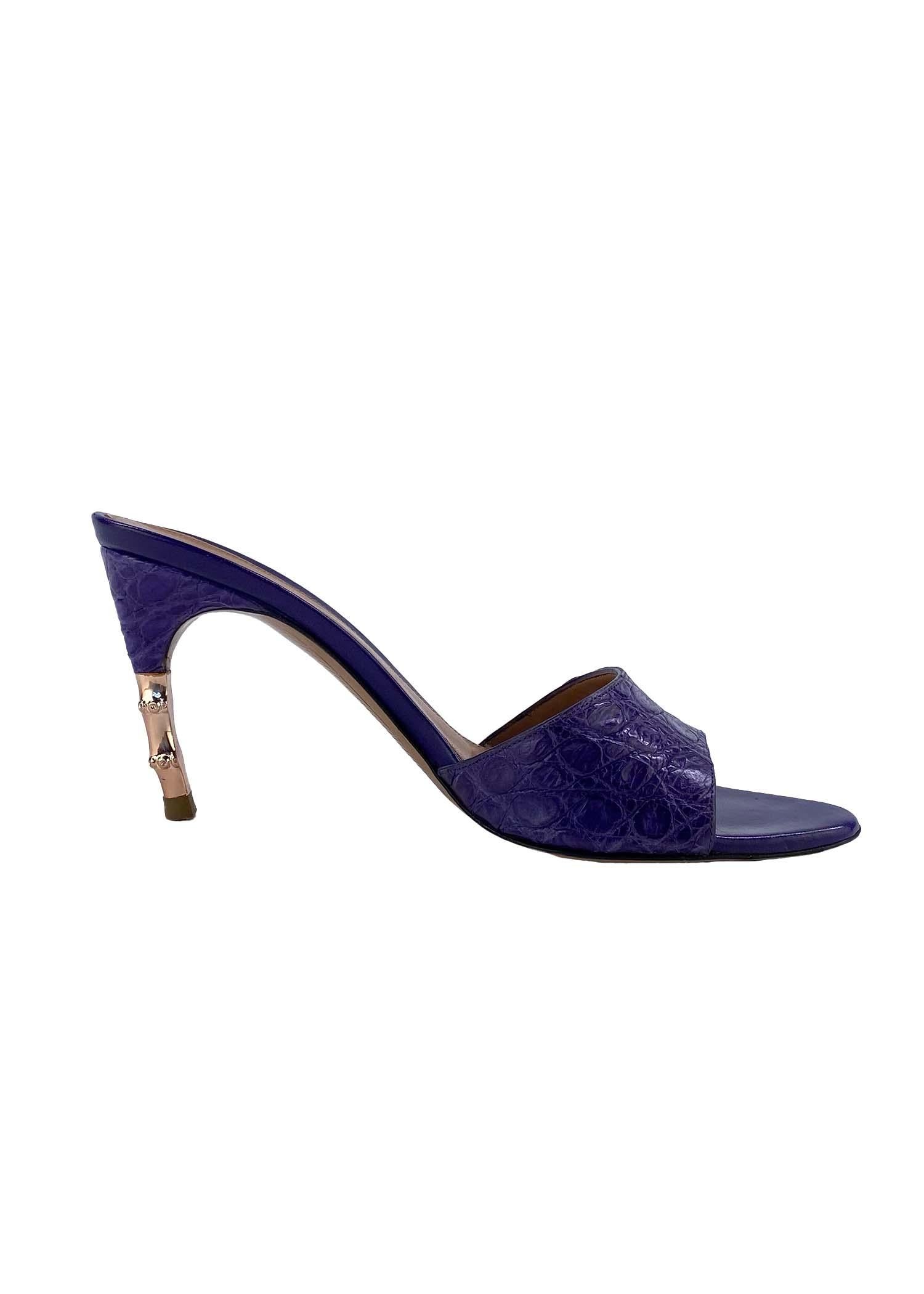 Presenting a stunning pair of crocodile Gucci heel slides, designed by Tom Ford. This beautiful pair of heels are constructed of purple crocodile skin at the exterior and leather at the interior. The shoes are a part of Ford's Spring/Summer 2004