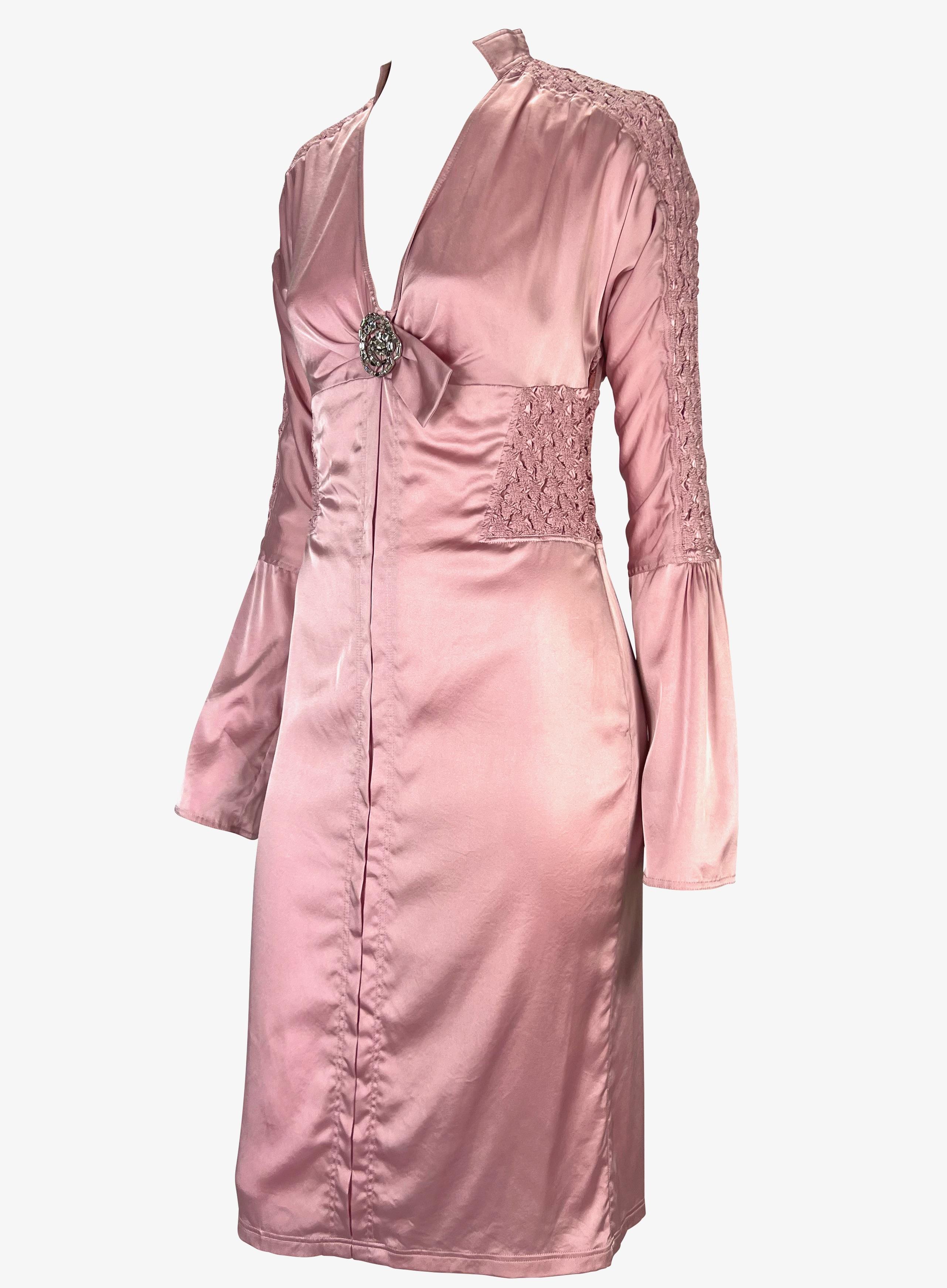 Presenting a beautiful metallic pink silk ruched Gucci dress, designed by Tom Ford. From the Spring/Summer 2004 collection, this form-fitting dress features a v-neckline, stand-up collar, long bell-style sleeves, and an exposed back. Ruched fabric