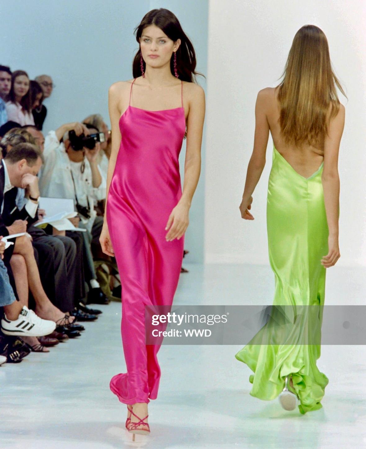 Presenting an incredible hot pink Ralph Lauren silk satin slip gown. From the Spring/Summer 2004 collection, this stunning creation, seen on the runway as look 45, exudes pure glamour and allure. Crafted entirely from luxurious hot pink silk satin,