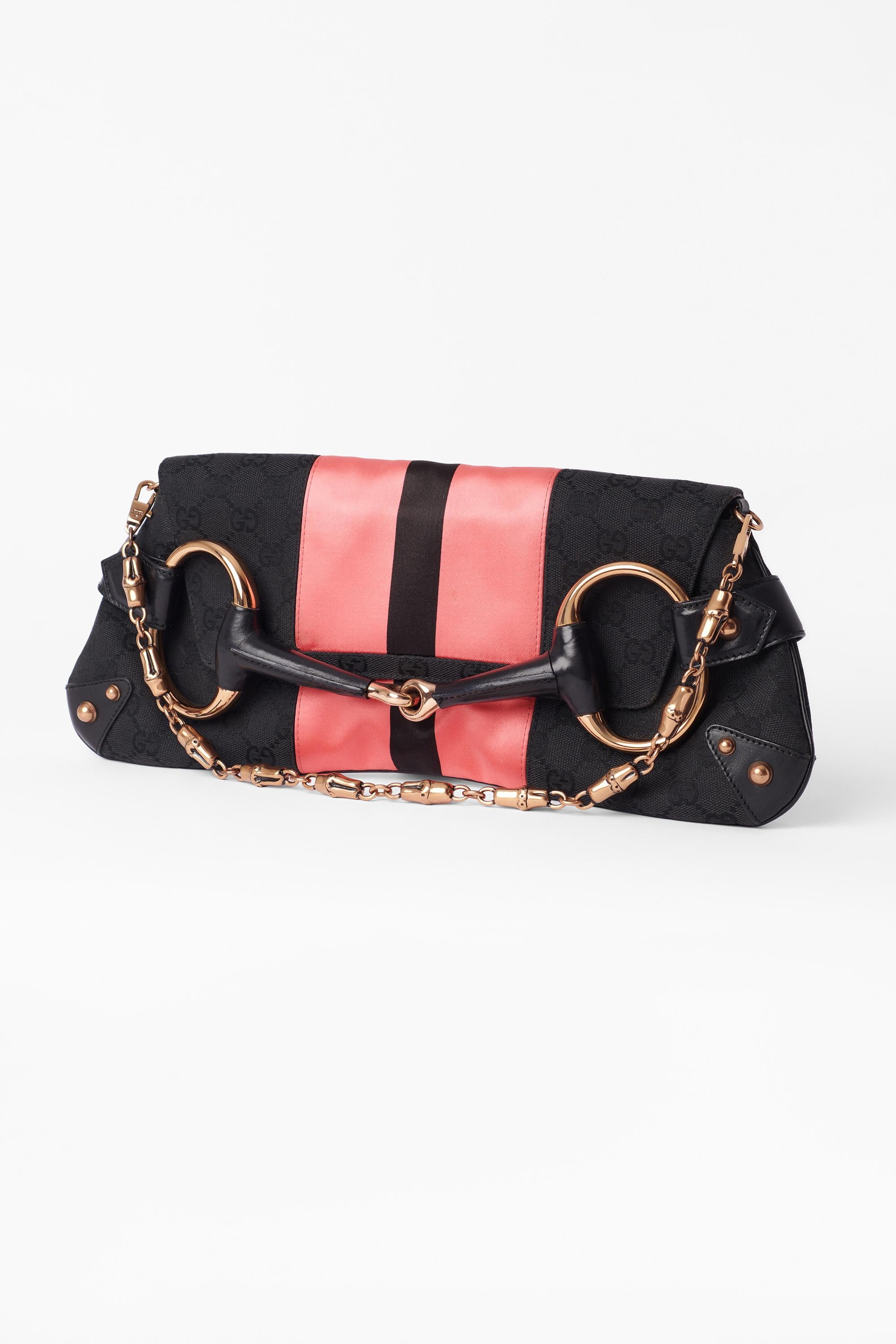 Tom Ford S/S 2004 black and pink GG monogram horsebit clutch, collectors item. Features signature horsebit detailing, black GG canvas and pink satin, detachable chain strap with Gucci branded magnetic closure and interior pocket. In excellent