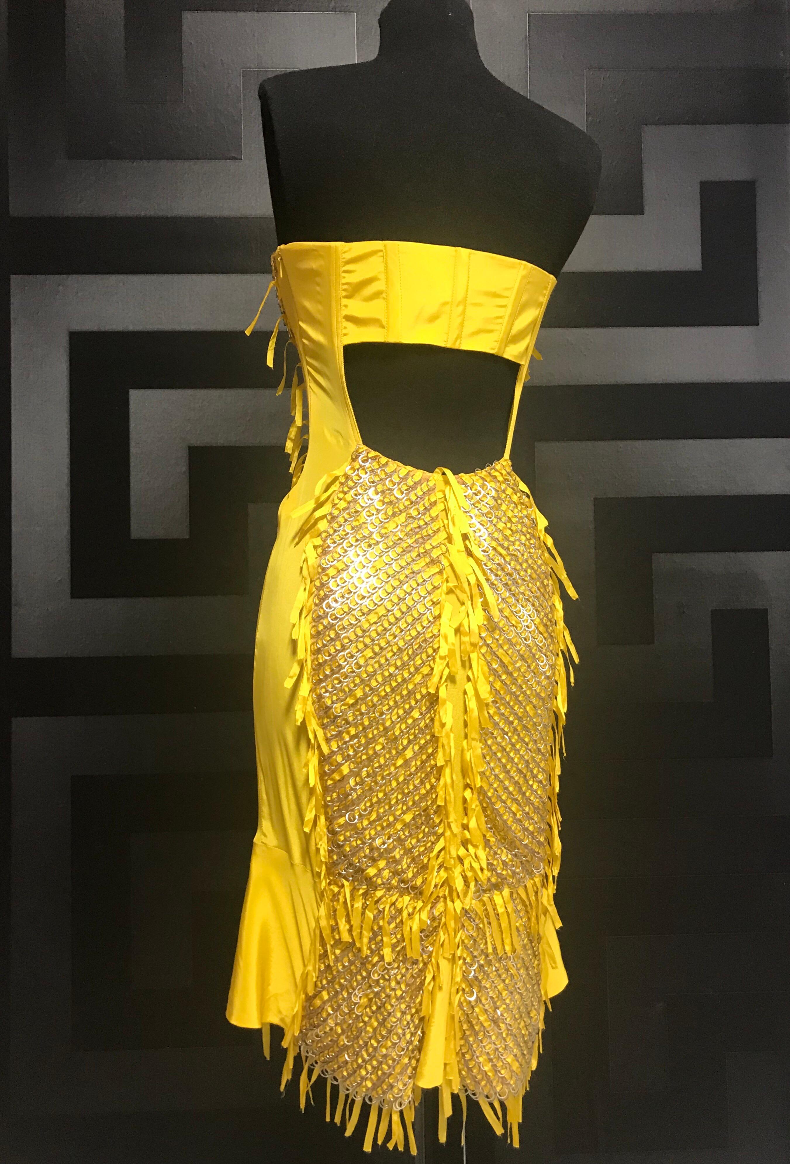 S/S 2004 Tom Ford for Gucci 

Embellished Strapless Silk Dress 
Delicate silk is finished with metal rings laced thru with matching ribbons. 
Side zipper closure.
Boned bodice and cut-out back. 

The dress is featured in Tom Ford Book and it's among