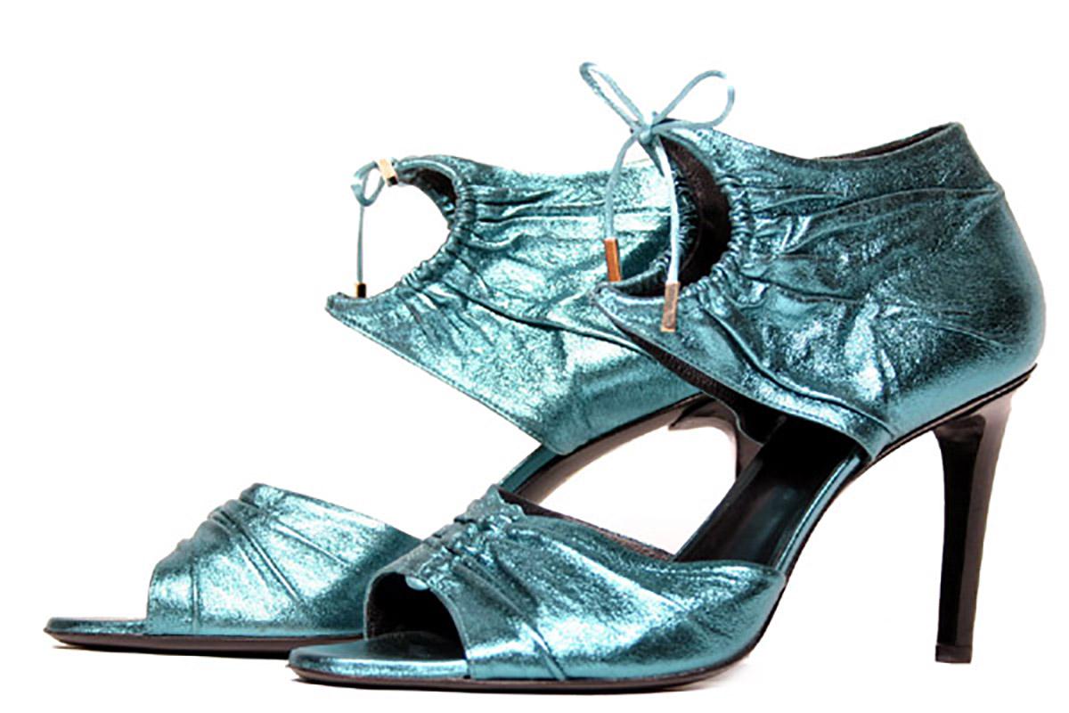 S/S 2004 Tom Ford for Gucci lame leather sandals

Tom Ford knows how to create shoes that'll turn heads - and these shoes are no exception. Made from teal lamé that reflects the light, they're set on a 4 inch heel and finished with an artful keyhole