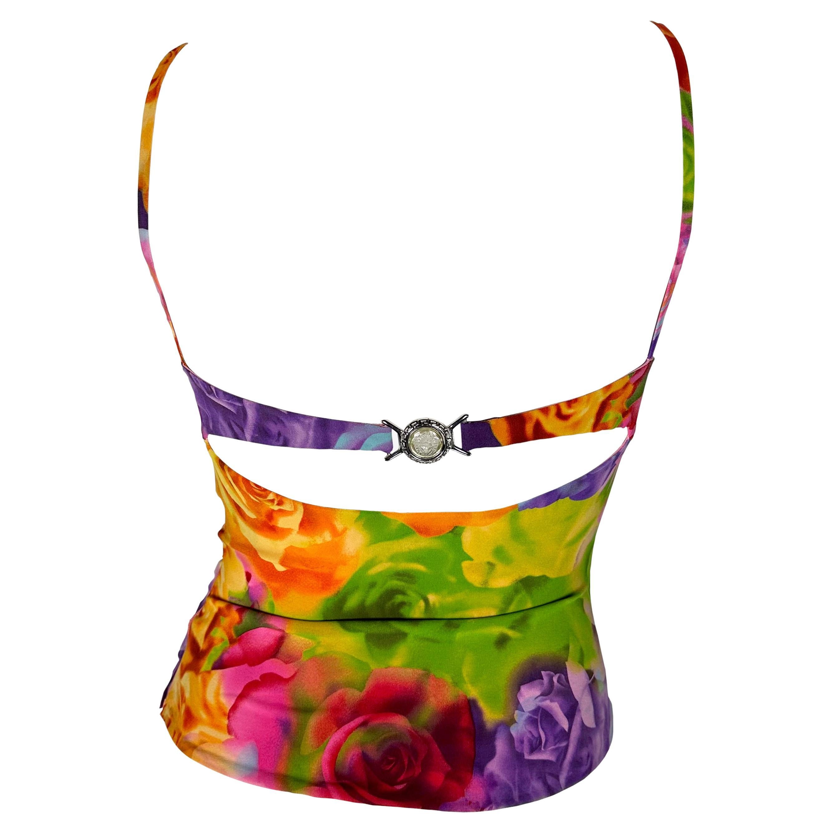 Presenting a bright floral Versace tank top, designed by Donatella Versace. From the Spring/Summer 2004 collection, this vibrant top is covered in a multicolored floral rose print. The top features spaghetti straps, a semi-sweetheart neckline with a