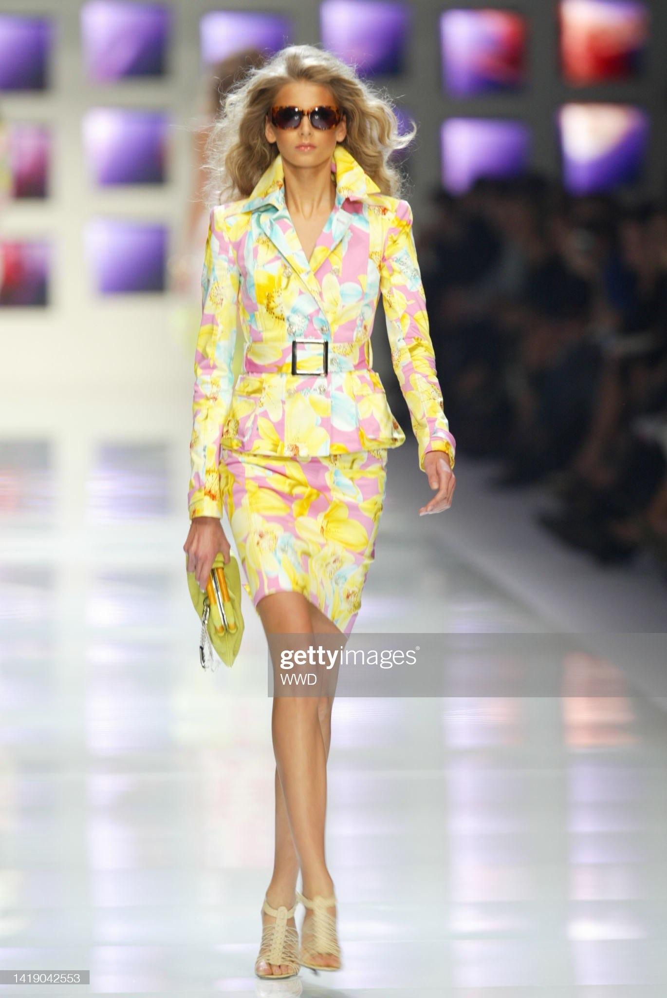 Presenting a vibrant floral yellow Versace skirt suit, designed by Donatella Versace. From the Spring/Summer 2004 collection, this set debuted on the runway as look 7, modeled by Hana Soukupova. A fusion of femininity and sophistication, the