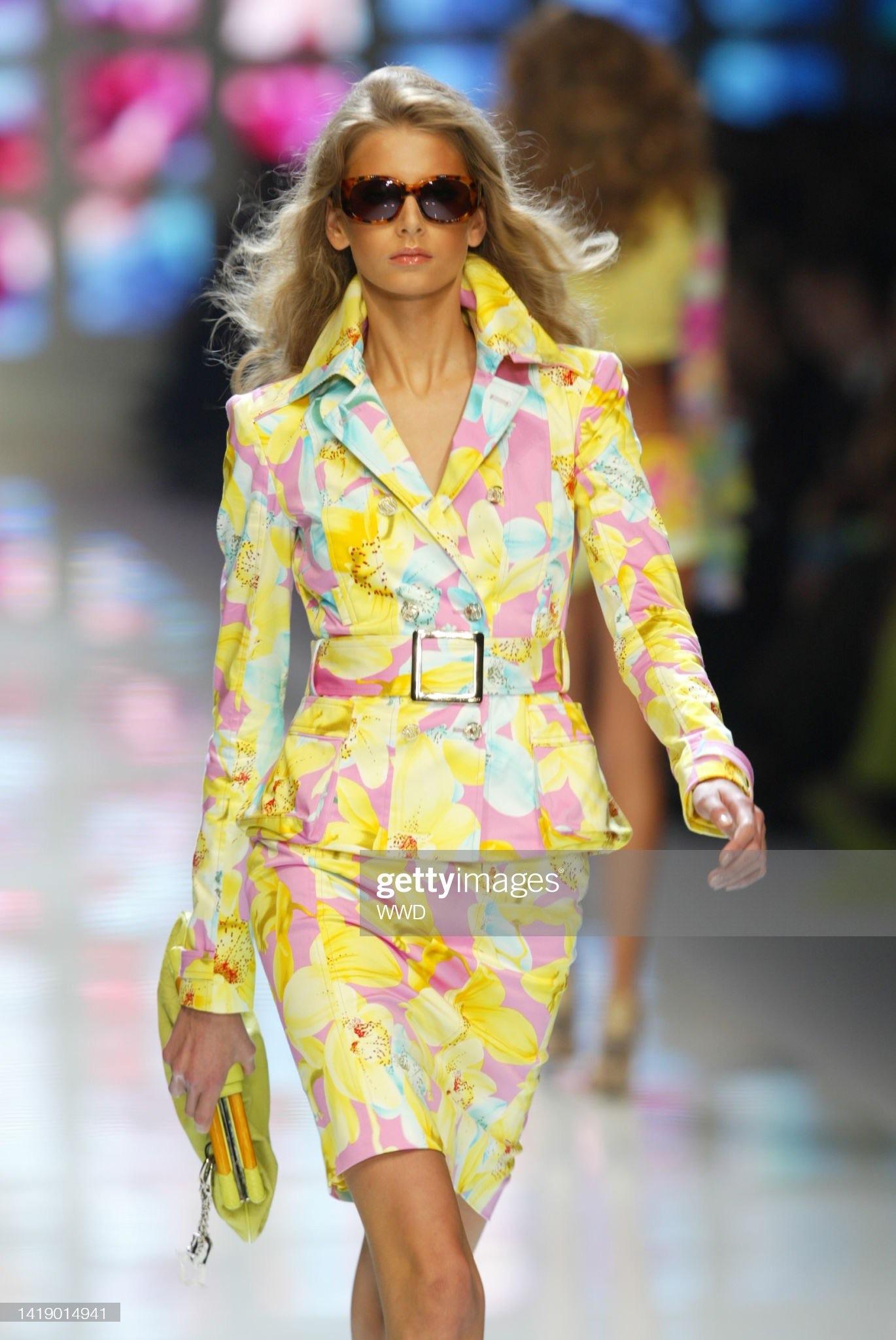 Presenting a vibrant floral yellow Versace skirt suit, designed by Donatella Versace. From the Spring/Summer 2004 collection, this set debuted on the runway as look 7, modeled by Hana Soukupova. A fusion of femininity and sophistication, the