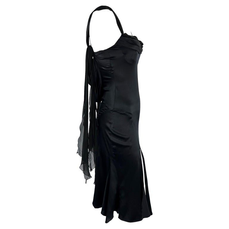 TheRealList presents: a black Versace halterneck buckle dress, designed by Donatella Versace. From the Spring/Summer 2004 collection, this beautiful dress features ruching at the waist, a handkerchief-style skirt, and a semi-exposed back. This dress