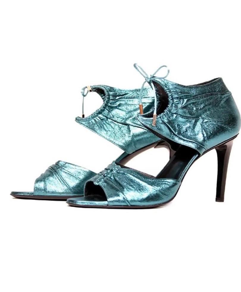 S/S 2004 Tom Ford for Gucci 
Metallic Leather Sandals
Tom Ford knows how to create shoes that'll turn heads - and these shoes are no exception. 
Made from teal metallic that reflects the light, they're set on a 4 inch heel and finished with an