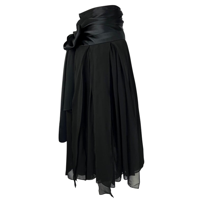 TheRealList presents: a black silk pleated Yves Saint Laurent Rive Gauche skirt, designed by Tom Ford. From the Spring/Summer 2004 collection, this fabulous flare skirt features wispy black chiffon that drapes from the hips. An incredible piece of