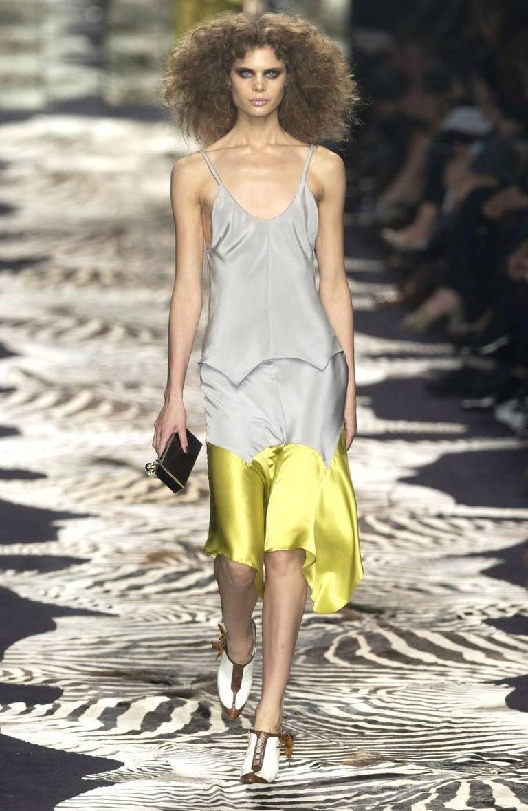 Presenting a handkerchief style dress by Tom Ford for Yves Saint Laurent Rive Gauche's Spring/Summer 2004 collection. This piece debuted as look 21 on Adina Fohlin in Ford's final spring collection for YSL and features tonal grey velvet straps. The