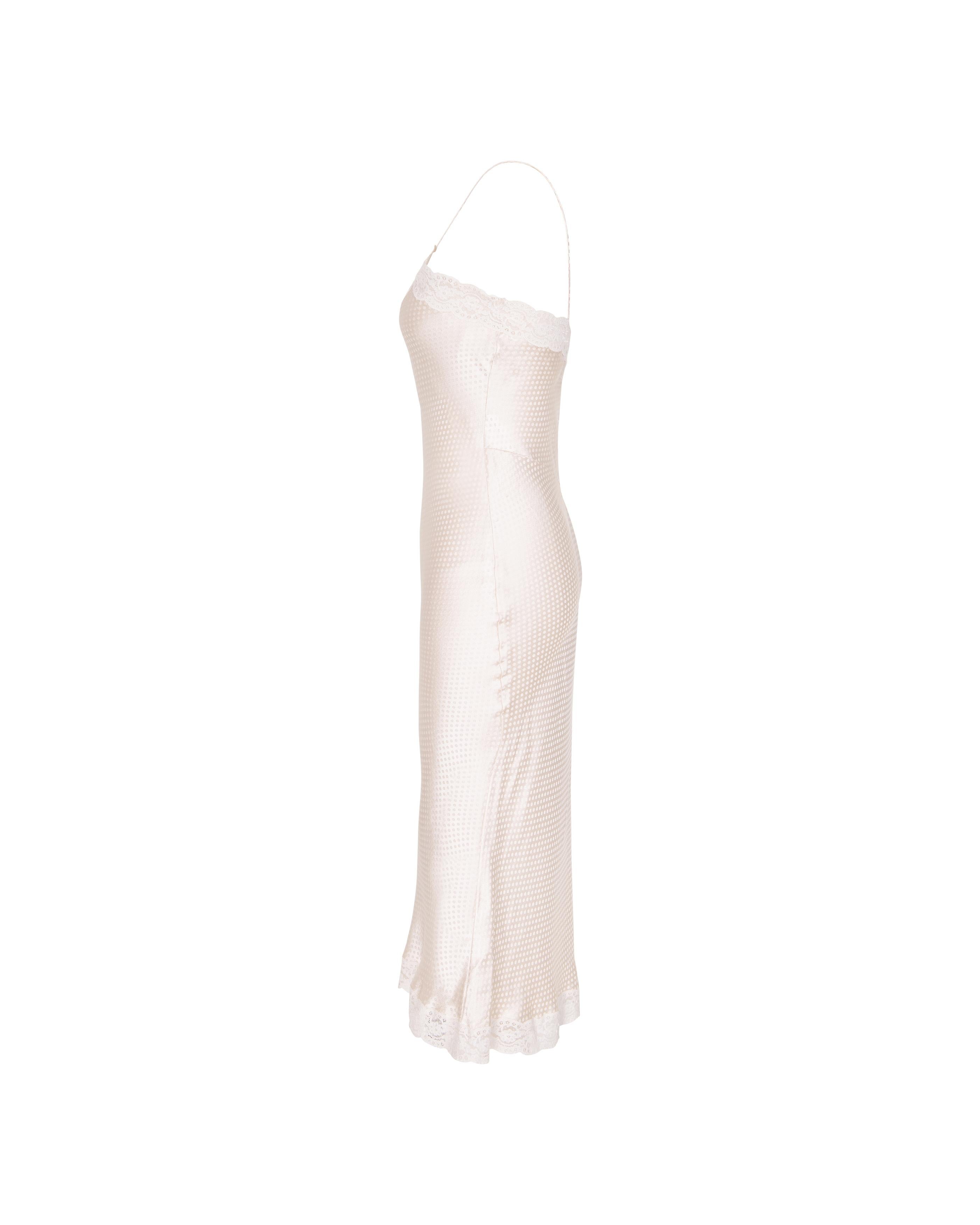 S/S 2005 Christian Dior by John Galliano polka dot bias cut cream slip dress with lace details. Sleeveless ecru midi slip dress with woven dot details throughout, and lace trim at bust and hem. Additional fabric allotment at straps allows for straps