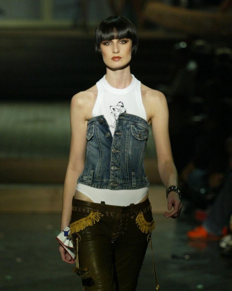 From Dsquared2’s Spring/Summer 2005 collection, this strapless denim corset top features structured boning and a button-down front. Designed to mimic a classic jean jacket, it includes flap pockets, contrast stitching, and adjustable waist tabs.