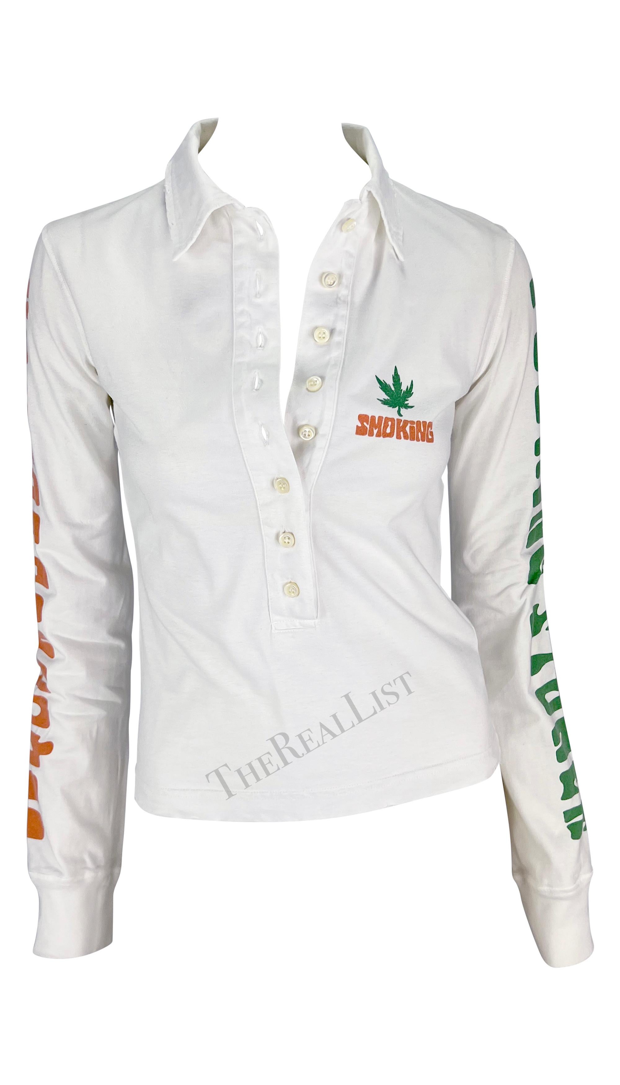 Presenting a distressed white Dsquared2 rugby-style shirt. From the Spring/Summer 2005 collection, this chic top features distressing throughout, a plunging button-up neckline, a pot leaf and 'smoking' screen printed at the bust, and 'fucking