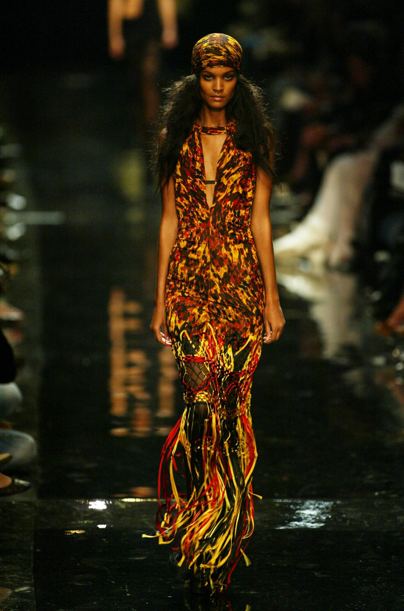 S/S 2005 Jean Paul Gaultier abstract tortoiseshell print gown with bright, colorful macrame fringe. Semi-sheer stretch jersey halter neck gown with tortoiseshell print upper and orange, green and yellow macrame fringe from hip to hem. Semi-open