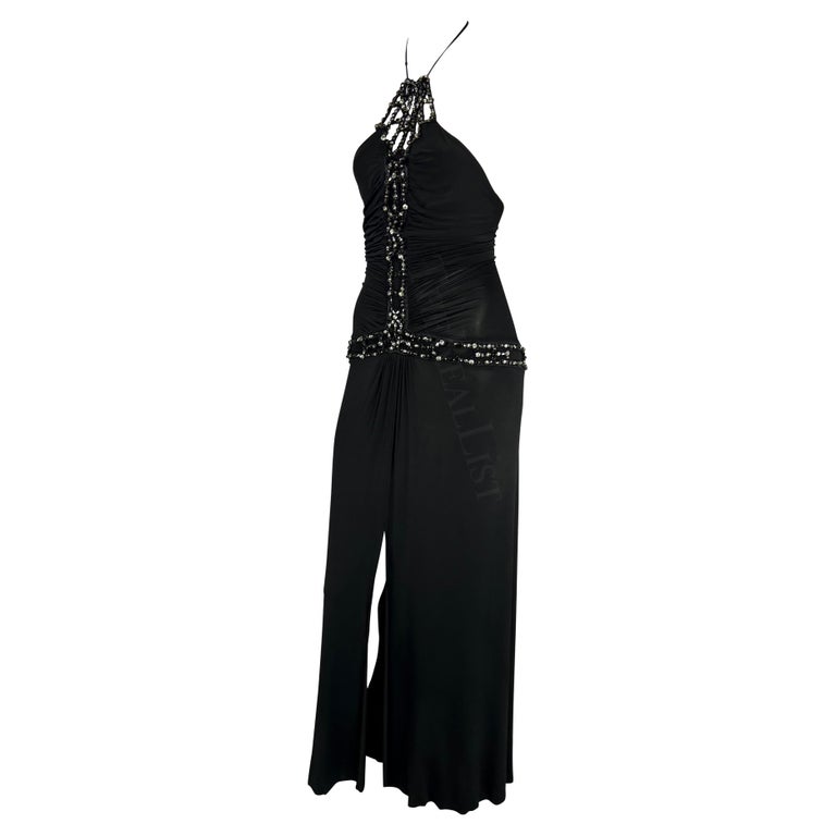 TheRealList presents: a fabulous black Roberto Cavalli slinky gown. From the Spring/Summer 2005 collection, this full-length dress features a halter neck and rhinestone embellishments that go down the front of the dress and around the hips. This