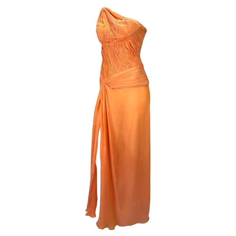 TheRealList presents: a stunning bright orange ruched Roberto Cavalli gown. From the Spring/Summer 2005 collection, this asymmetric gown is constructed entirely of light persimmon silk chiffon. The dress features a single shoulder strap, ruched