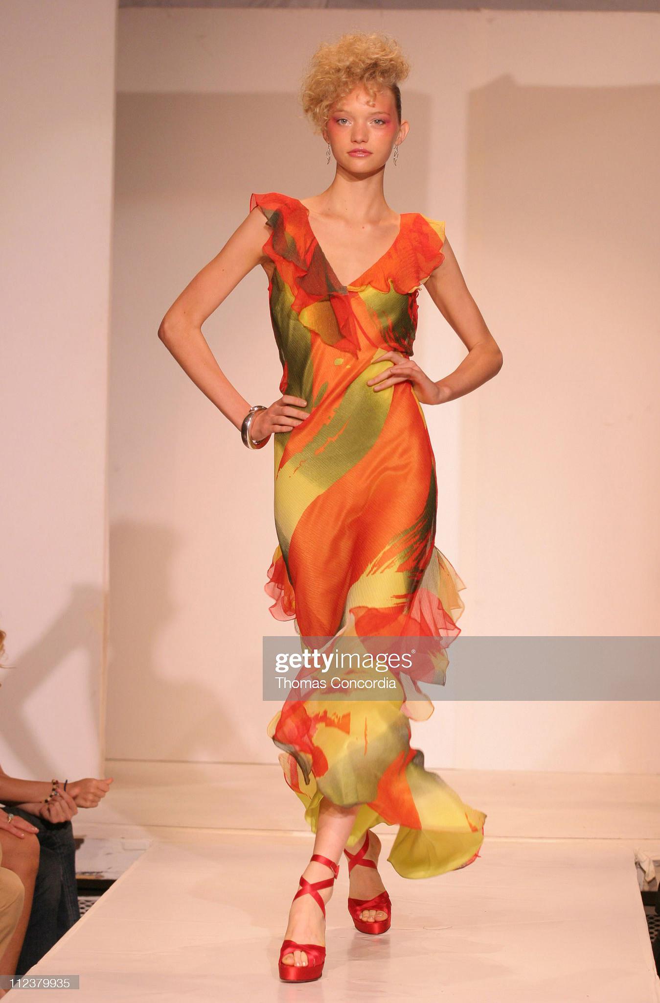 S/S 2005 Stephen Burrows bias cut abstract print gown with ruffle bust and hem. Bright red-orange, olive greens, and yellow hues in abstract, painterly pattern throughout. Semi-sheer, subtle metallic chiffon gown with yellow-green silk slip dress