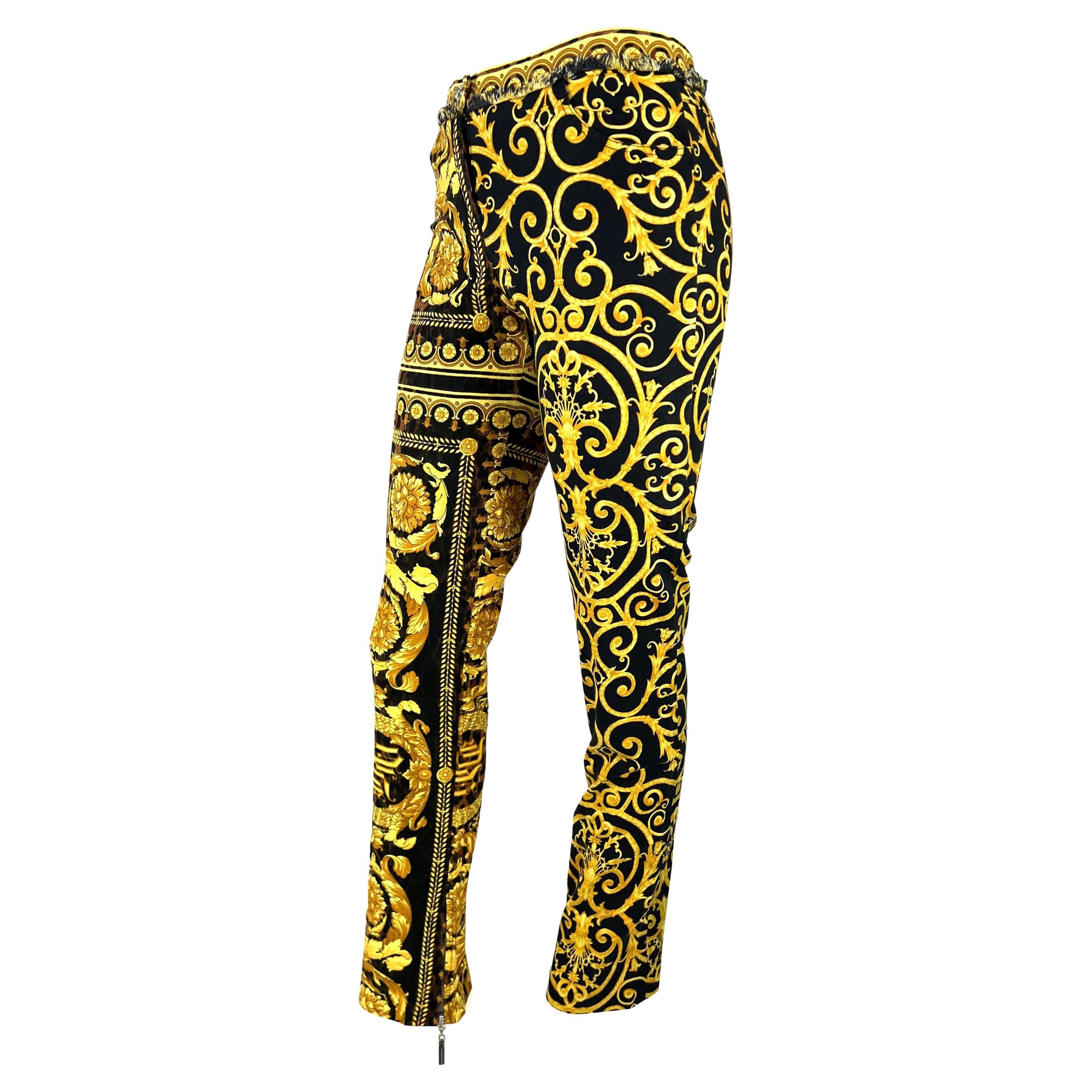 Presenting a pair of stunning yellow and black Versace baroque print jeans, designed by Donatella Versace. From the Spring/Summer 2005 Chaos Couture collection, this fabulous pair of jeans features Versace's famous baroque print atop a cheetah
