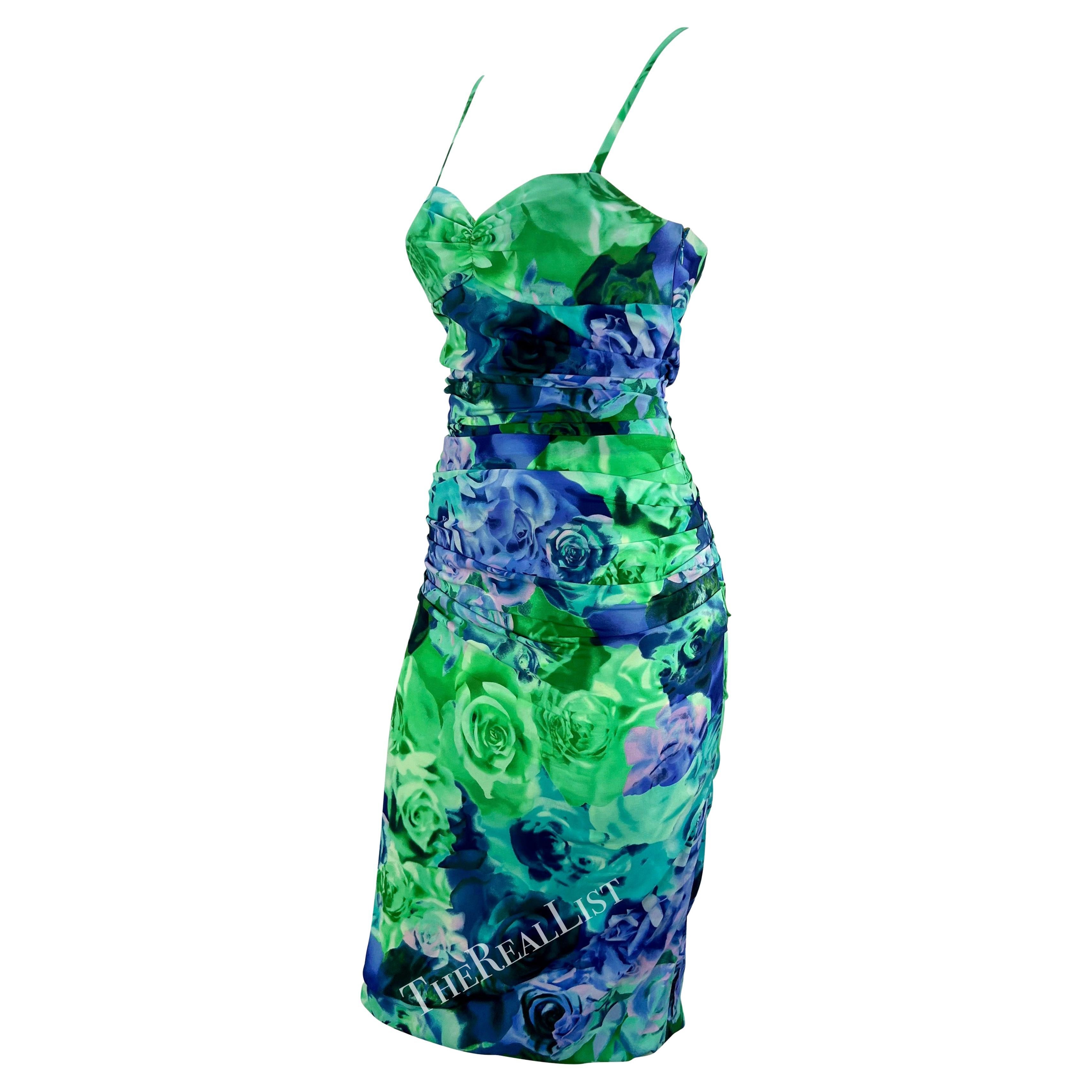 Presenting a gorgeous green rose print Versace mini dress, designed by Donatella Versace. From the Spring/Summer 2005 collection, this sexy mini dress features a sweetheart neckline, spaghetti straps, and ruching throughout. The sexy exposed back