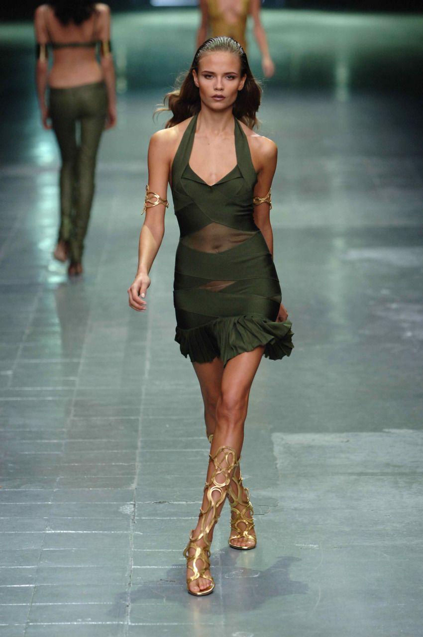 From Alexander McQueen’s Spring/Summer 2006 “Neptune” collection, this white halter dress is constructed from a stretch bandage knit that contours to the body. Featuring crossover paneling, sheer mesh inserts, and a pleated hem. The green version