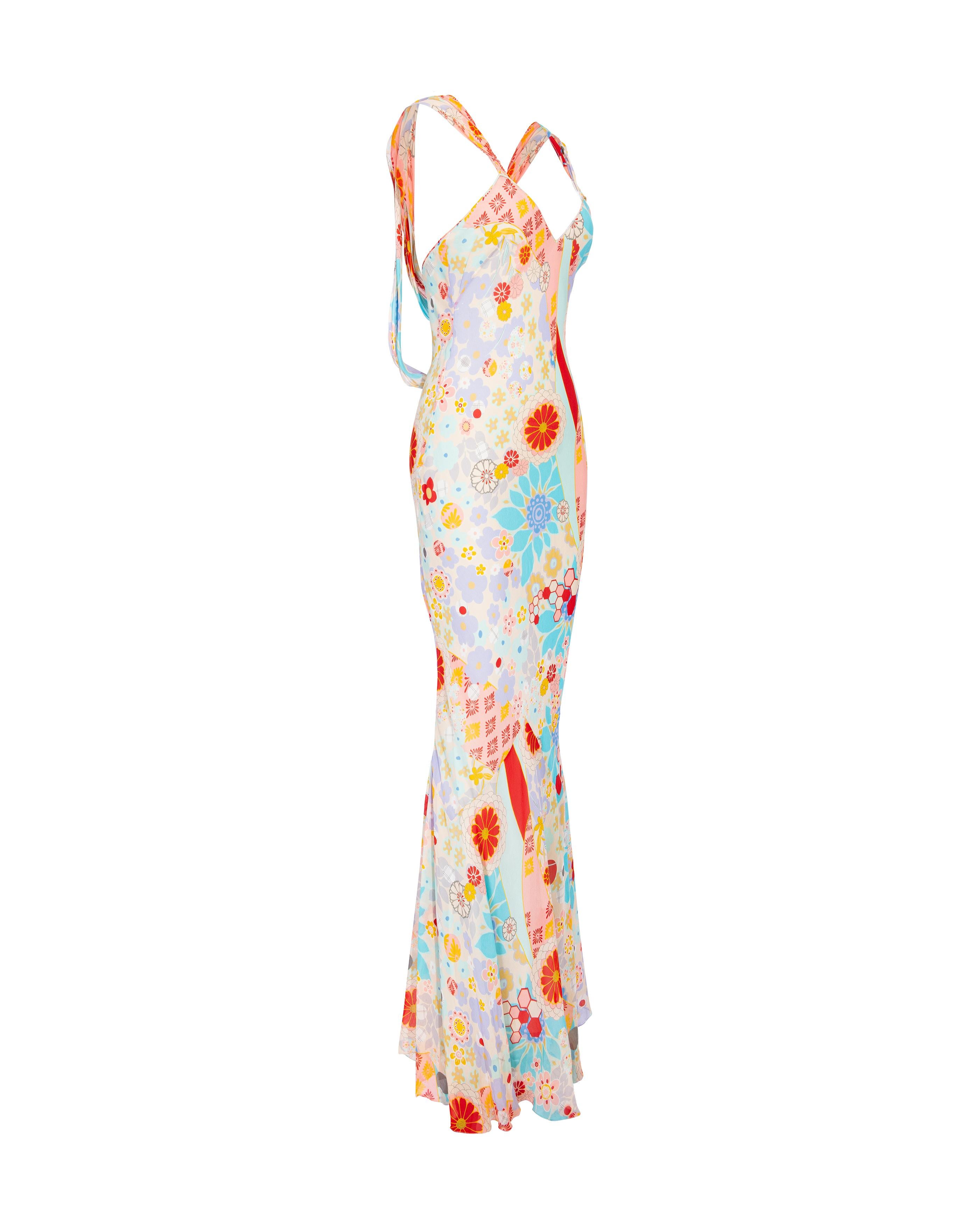 S/S 2006 John Galliano floral bias silk cut gown with back fabric button closure detail. Bias cut v-neck sleeveless gown with open drape back straps and long, full skirt. Multicolor bright floral pattern with geometric details. Back features