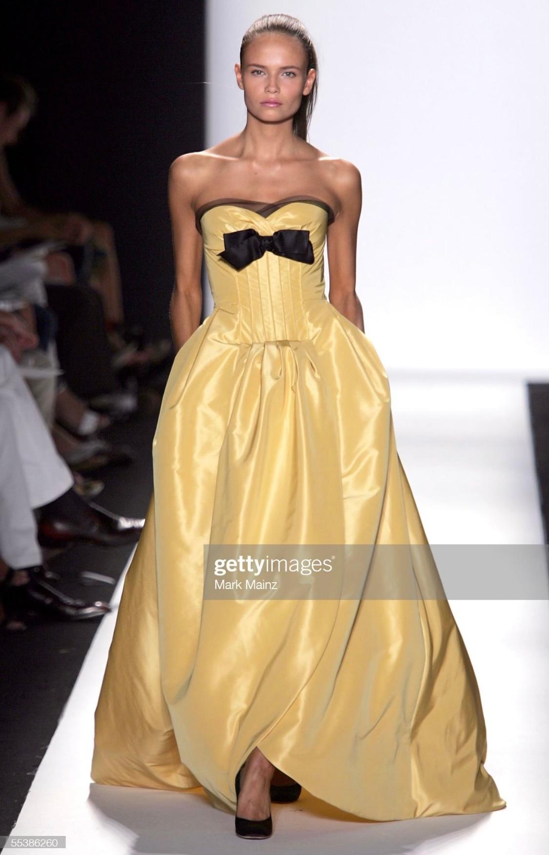 TheRealList presents: a stunning yellow silk taffeta Oscar de la Renta gown. From the Spring/Summer 2006 collection, this dress debuted on the season's runway as look 70 on Natasha Poly. This fabulous strapless gown features an internal boned