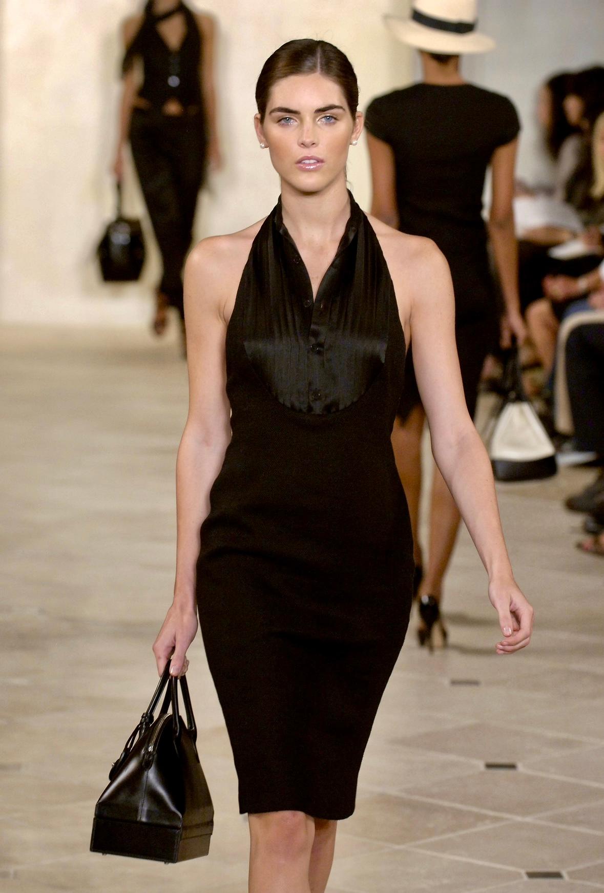 This stunning Ralph Lauren Purple Label halterneck mini dress from the Spring/Summer 2007 collection is the perfect modern yet sophisticated little black dress. This chic dress debuted on the season's runway as look 13, modeled by Hilary Rhoda, and