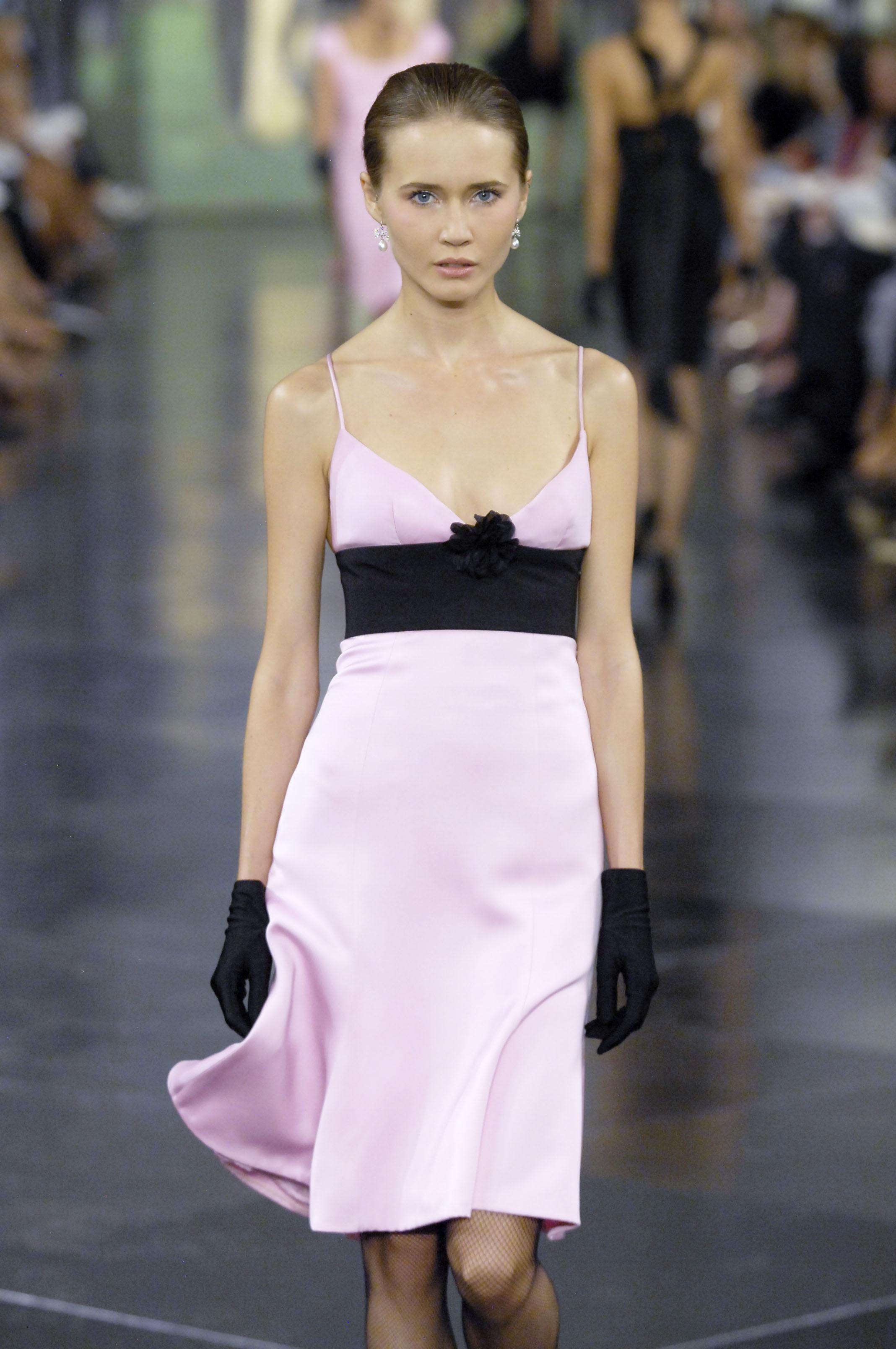 Part of Ralph Lauren’s 40th anniversary collection—an homage to “everything (he) ever loved”—this silk slip dress features a sleek black silhouette accented by a soft baby pink empire waist panel and a deep V-neckline framed by delicate spaghetti