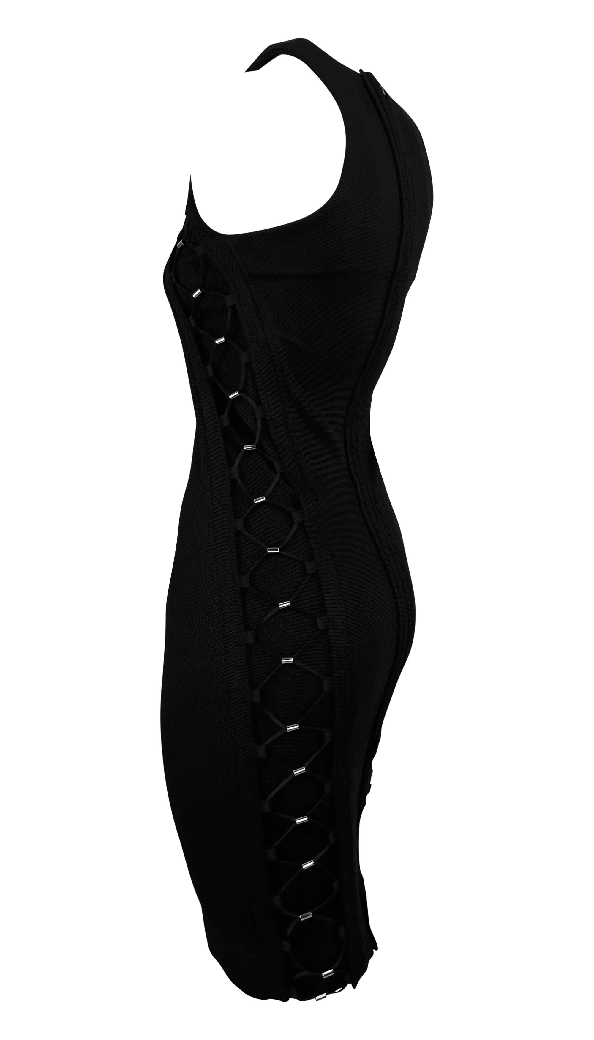 This Spring/Summer 2010 Gucci bodycon dress by Frida Giannini is crafted from black stretch fabric in a sleeveless, fitted silhouette. It features bungee-inspired lace-up detailing along the sides and upper chest, accented with silver-tone hardware.