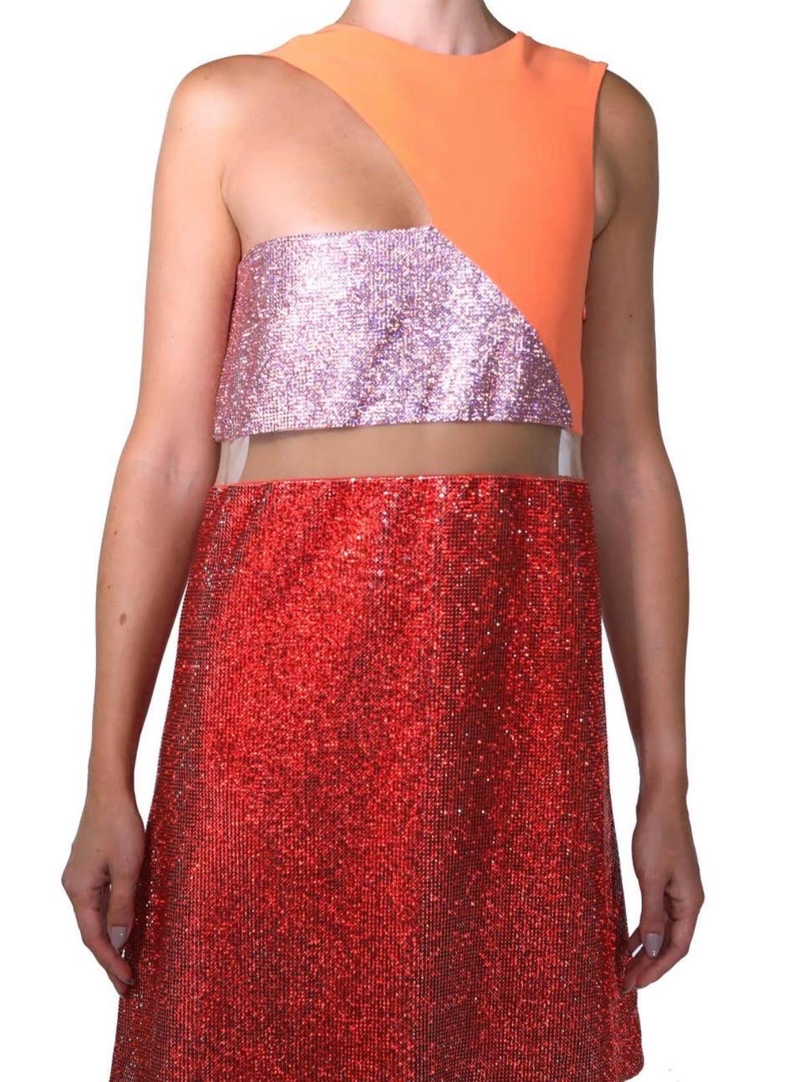 VERSACE
Actual runway sample Spring/Summer 2015 look # 43
Crystal embellished dress
Versace's mini dress sings high-octane glamour. 
It has straight silhouette with a sheer mesh tulle panel and red/pink Swarovski crystal embellishment.
Hidden zip