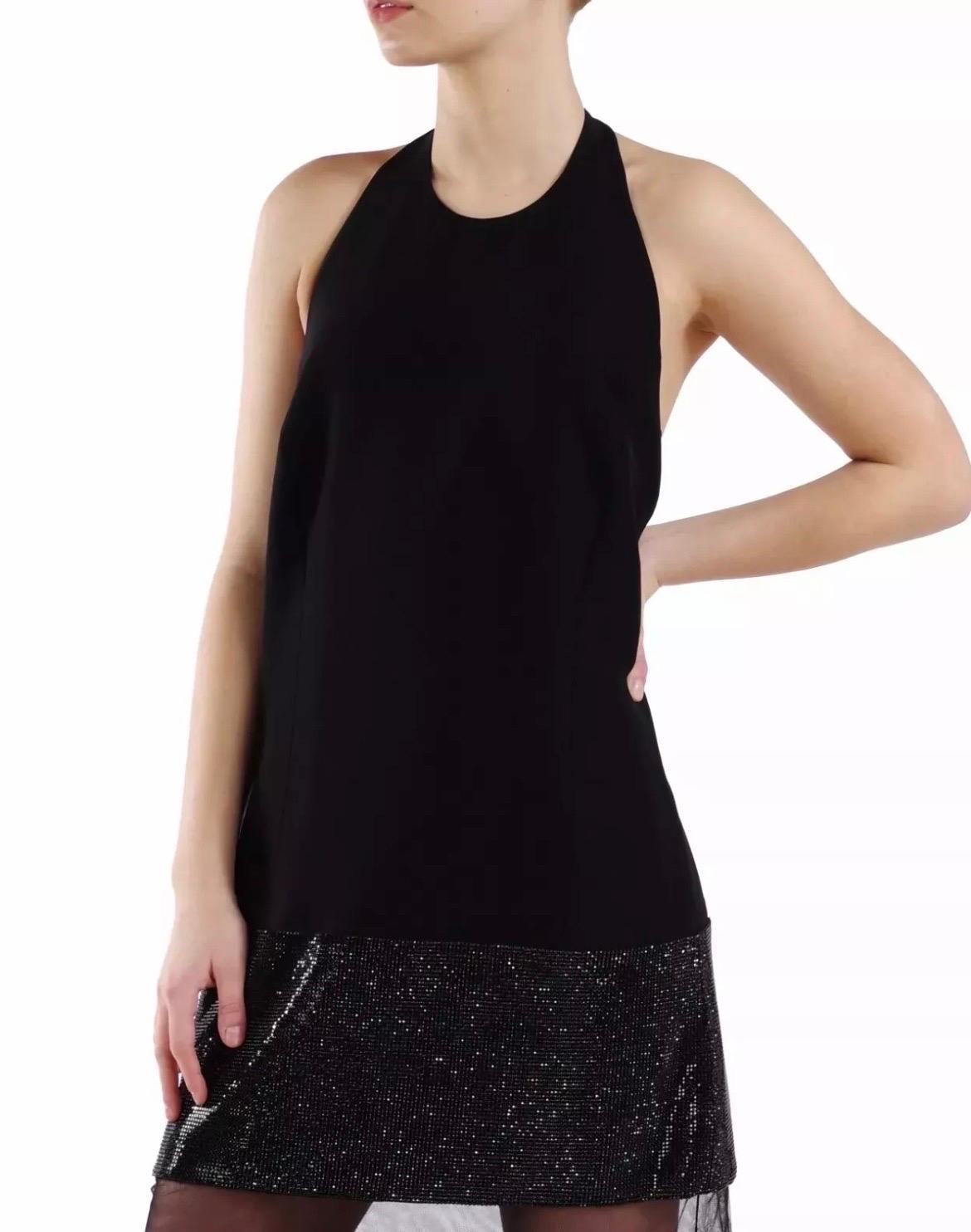 VERSACE 
Crystal embellished long dress.

Versace's black silk dress sings high-octane glamour. 
It has straight silhouette with a sheer mesh tulle panel and black Swarovski crystal embellishment adding real impact.
Fully lined.
Hidden zip