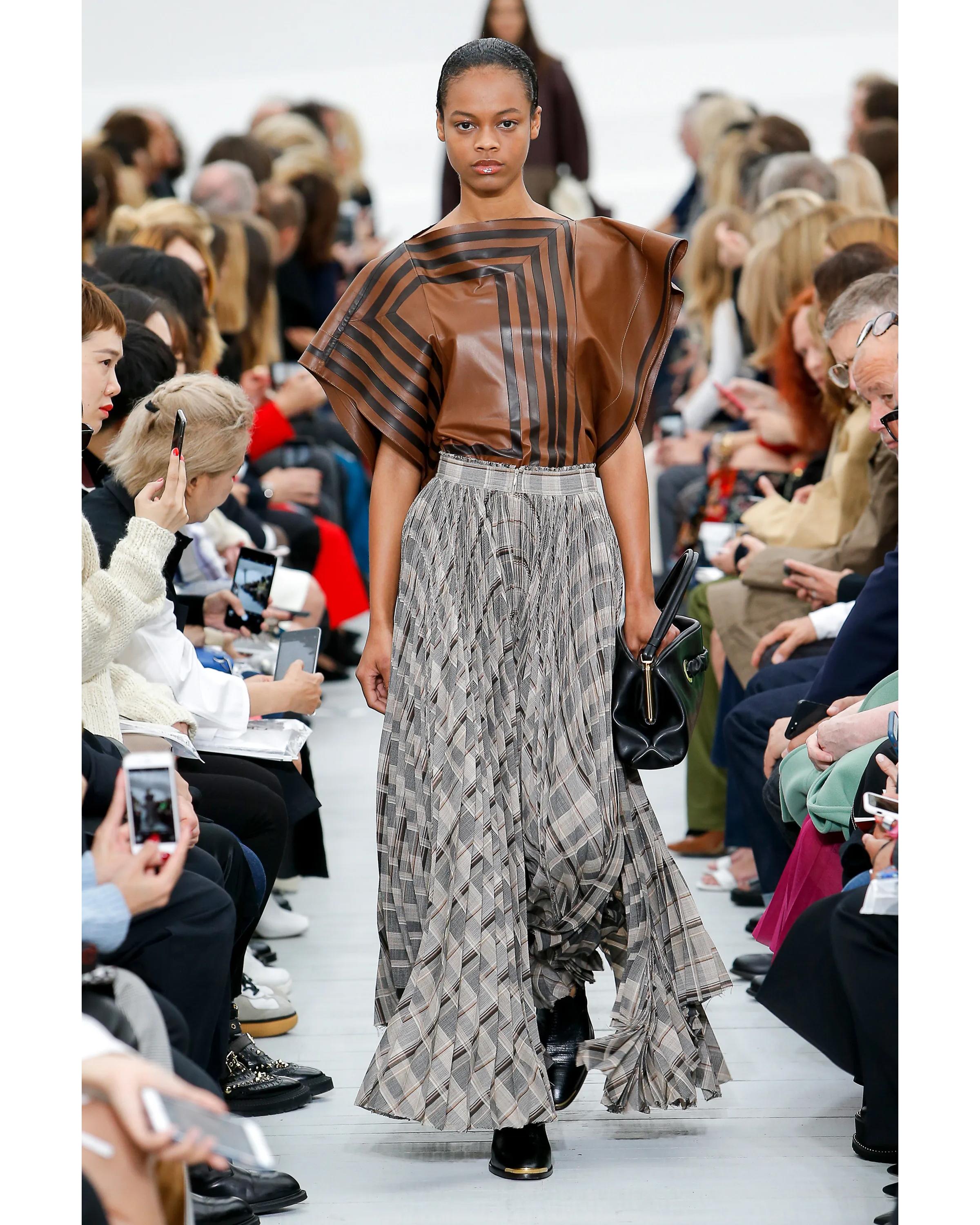 S/S 2018 Old Céline by Phoebe Philo black and brown contrast stripe leather top. Batwing-style lambskin leather top with contrasting geometric black and brown stripe motif throughout. Fitted waist and wide open asymmetrical style sleeves create